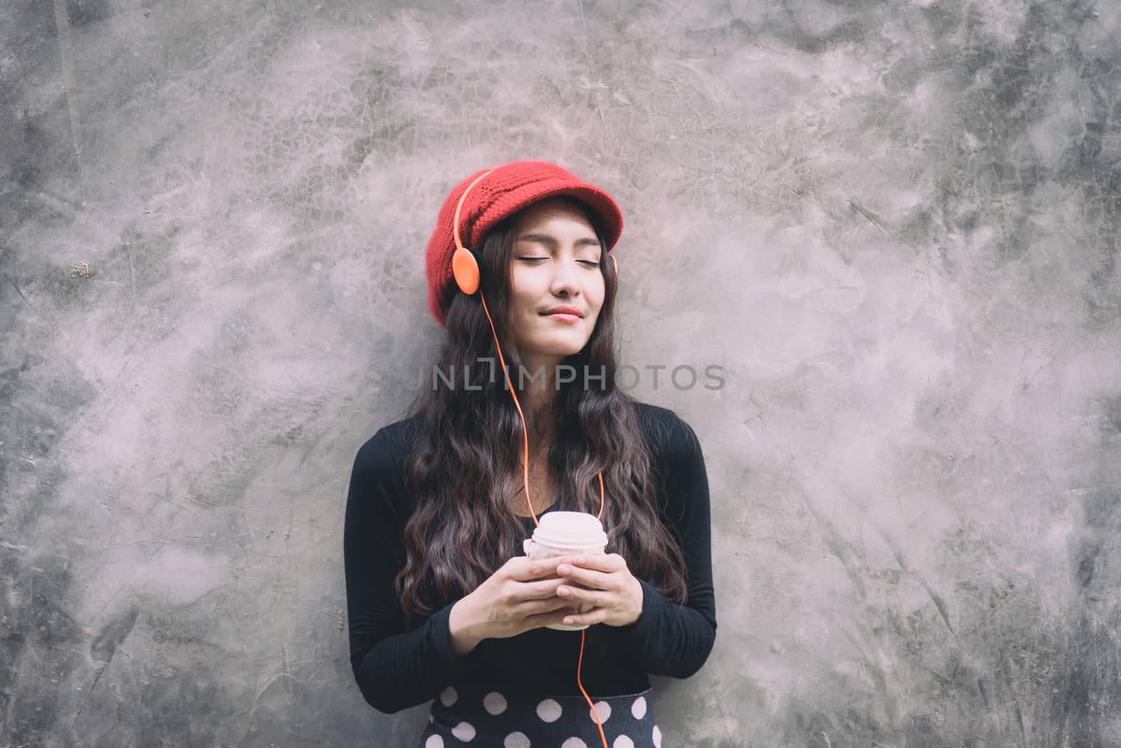 Asian portrait woman with red hat and black clothes has holding  by animagesdesign