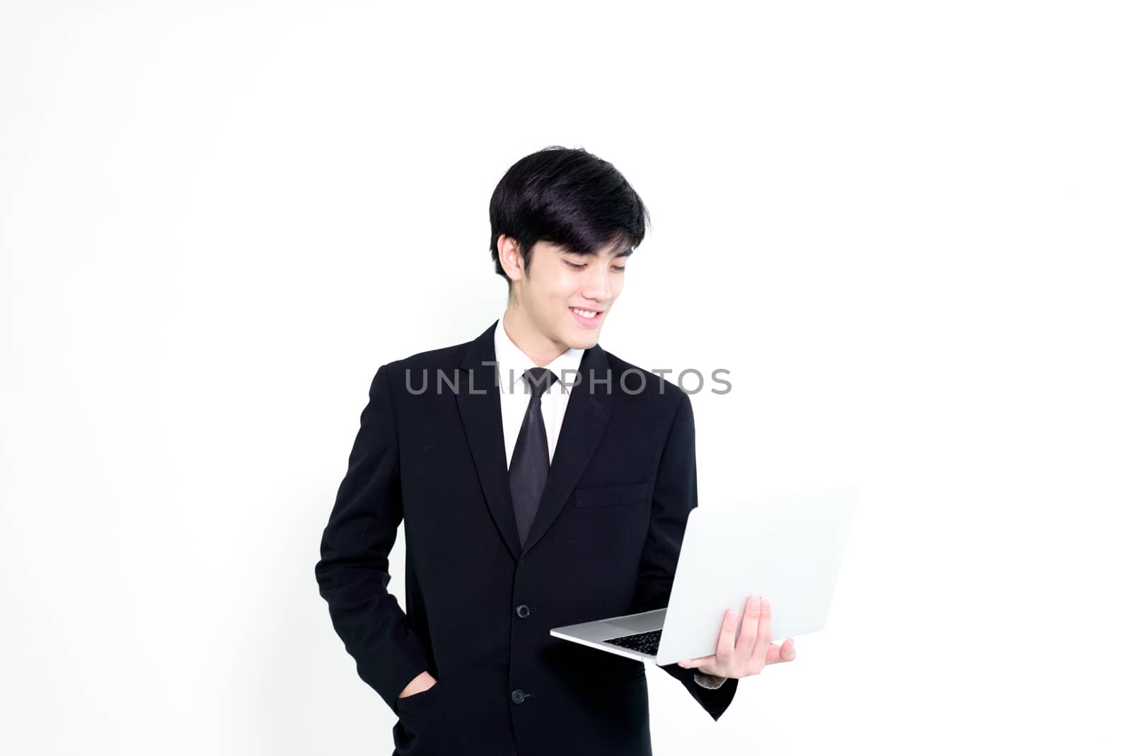 Asian business handsome man has holding laptop for woking with h by animagesdesign