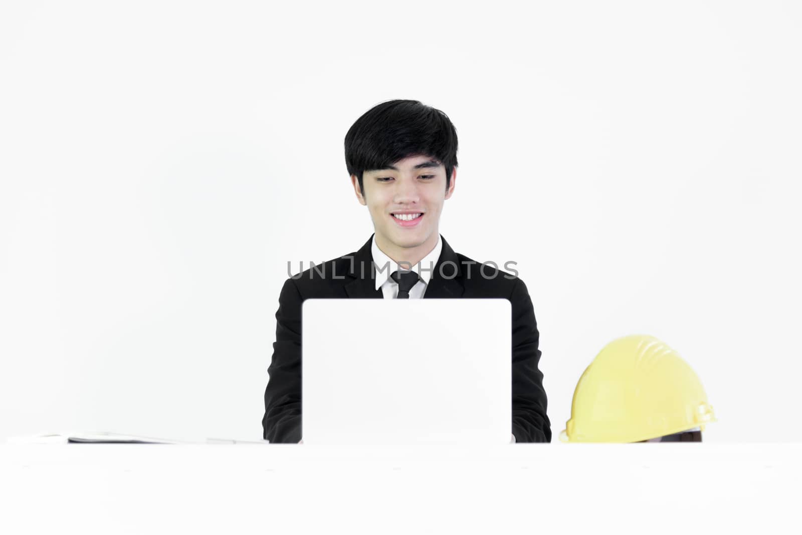 Asian manager businessman sitting at desk and working with lapto by animagesdesign