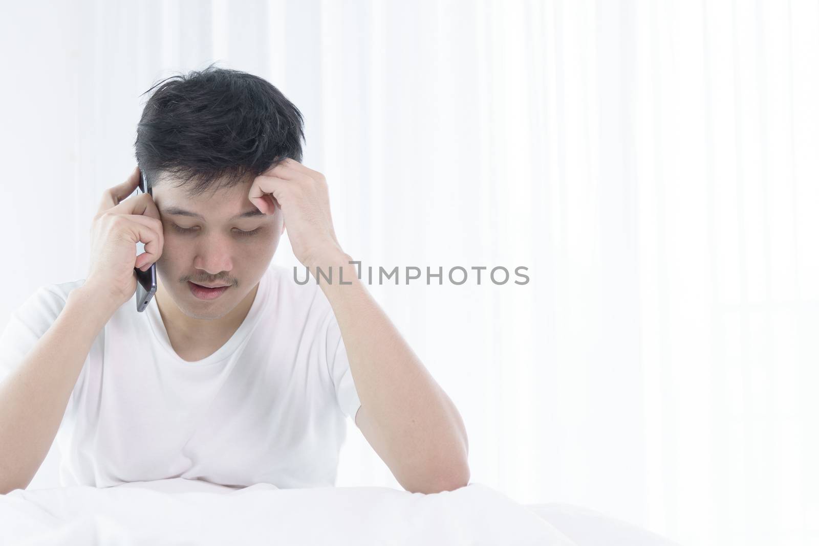 Asian man has wake up with talking about job before start workin by animagesdesign