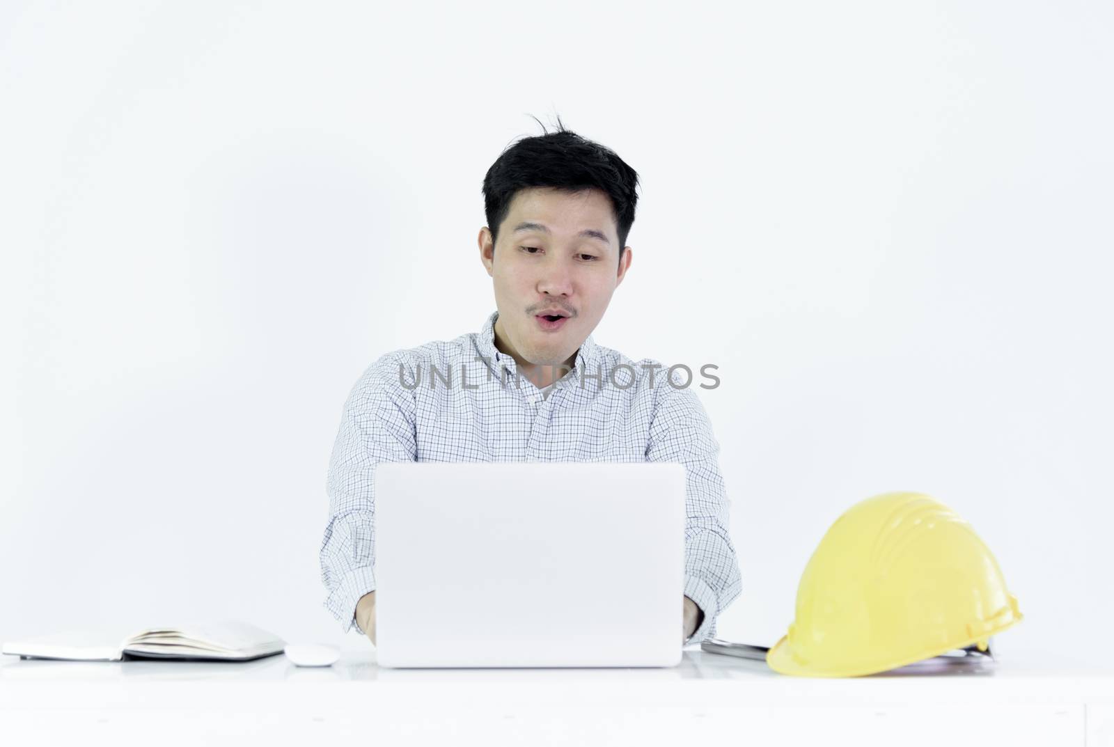 Asian employee engineer salary man sitting at desk and working with feeling successful and victory, isolated on white background.