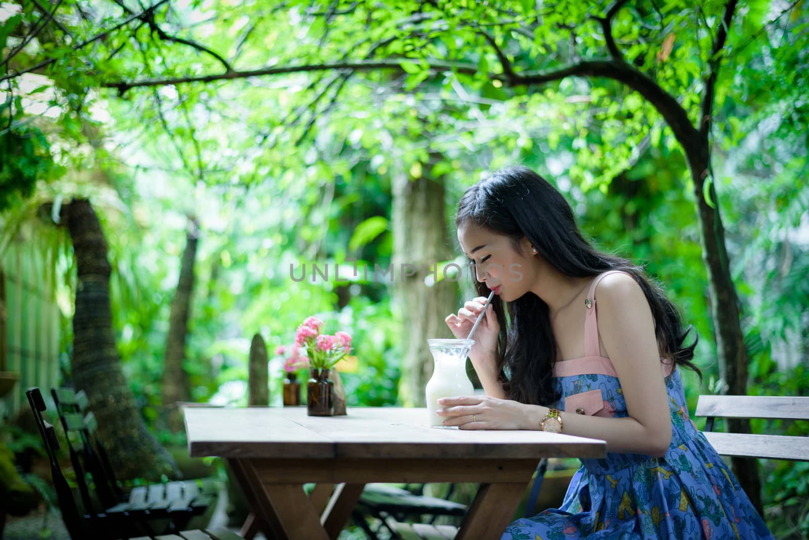 Asian pretty girl has drinkling ice white milk with happy and sm by animagesdesign