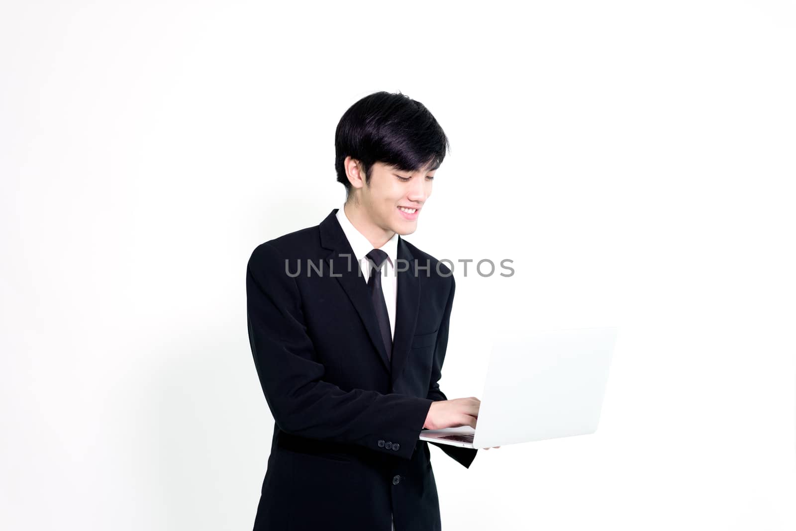 Asian business handsome man has holding laptop for woking with happy and relaxing isolated on white background.