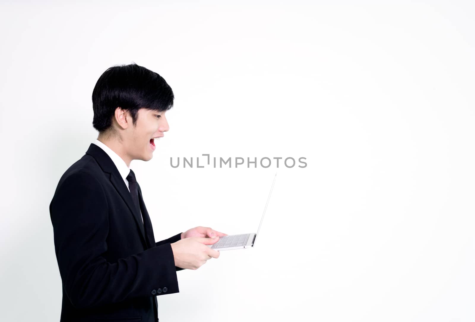 Asian business handsome man has holding laptop for woking with happy and relaxing isolated on white background.