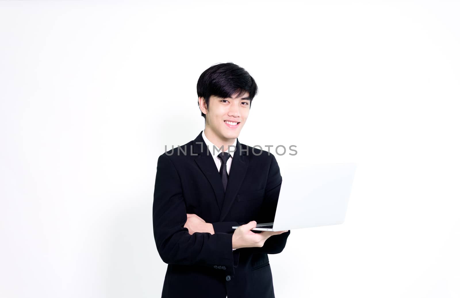 Asian business handsome man has holding laptop for woking with h by animagesdesign