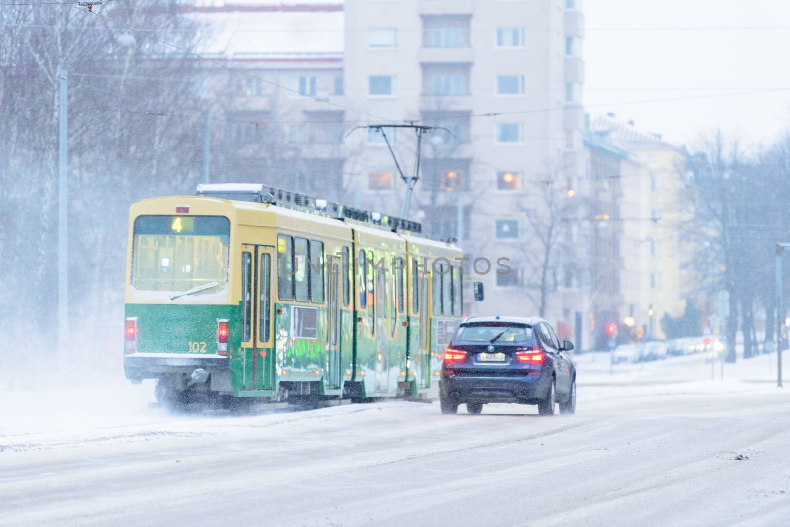 Editorial: Helsinki City, Finland, 21th December 2018. Train on the road with snow in winter season at Helsinki, Finland.