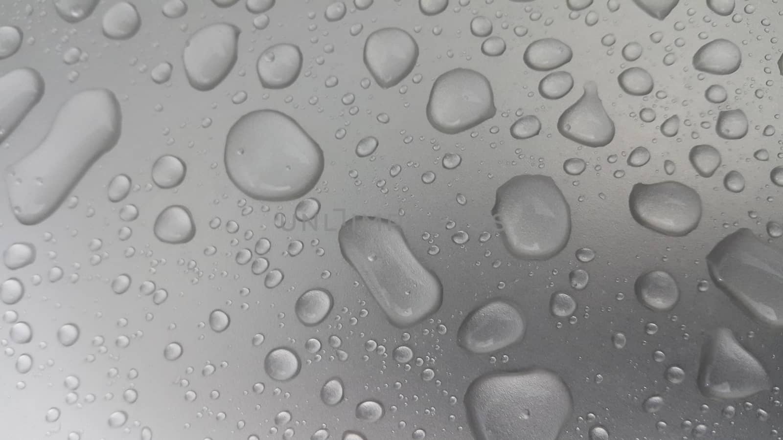 Water drops on grey silver color metallic sink by Photochowk