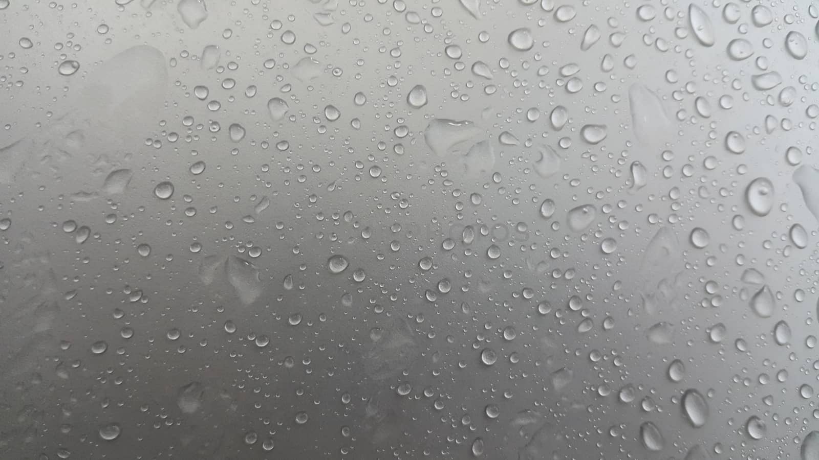 Water drops on grey silver color metallic sink