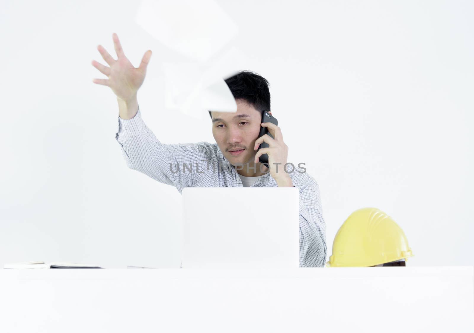 Asian employee engineer salary man sitting at desk throwing pape by animagesdesign