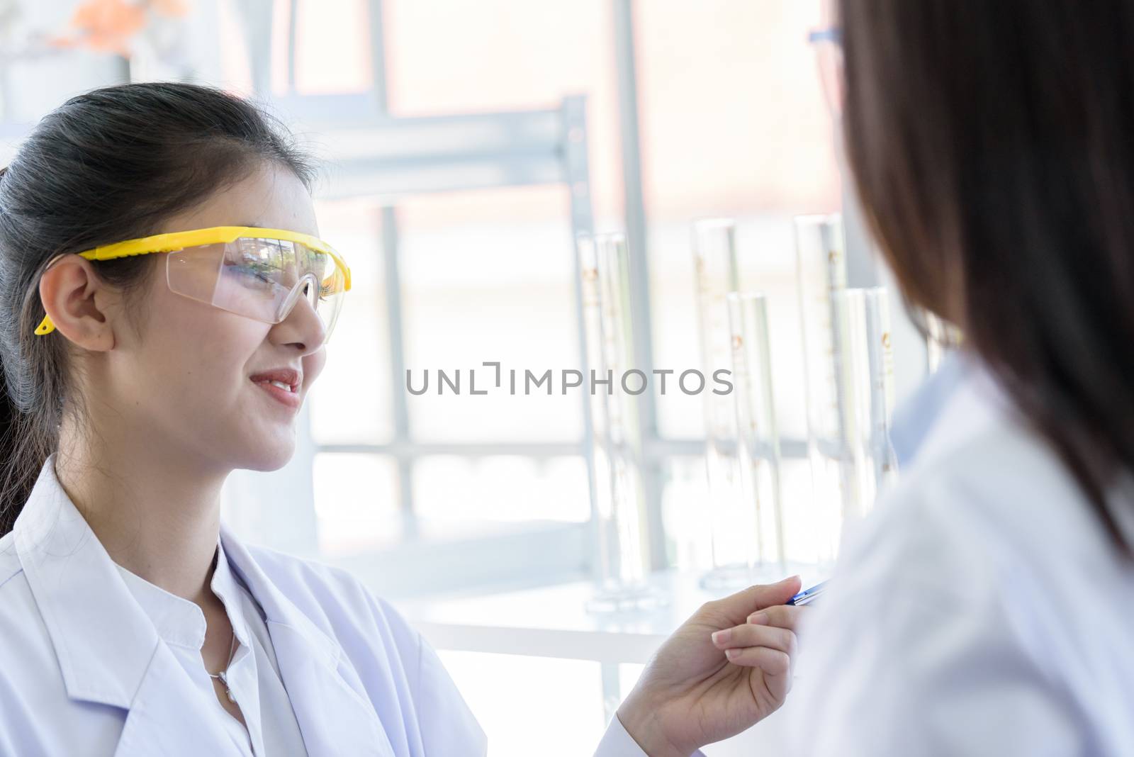 Asian young female working and research scientist together.