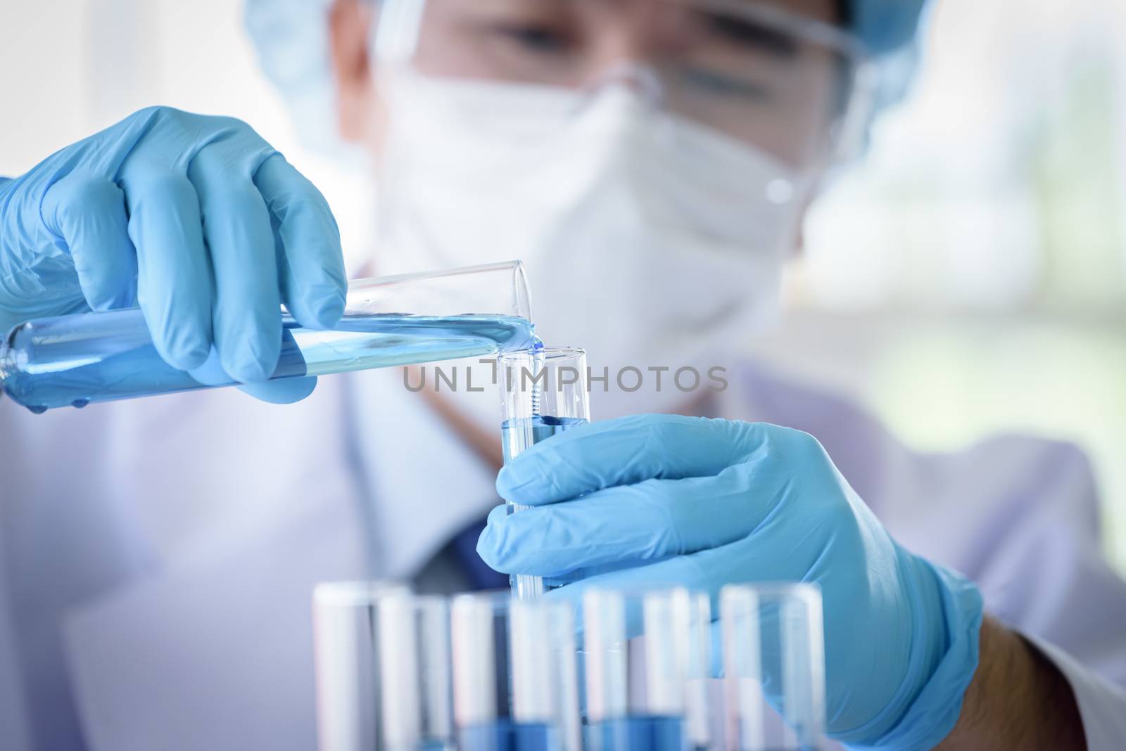 Asian man scientist researching  and learning in a laboratory.