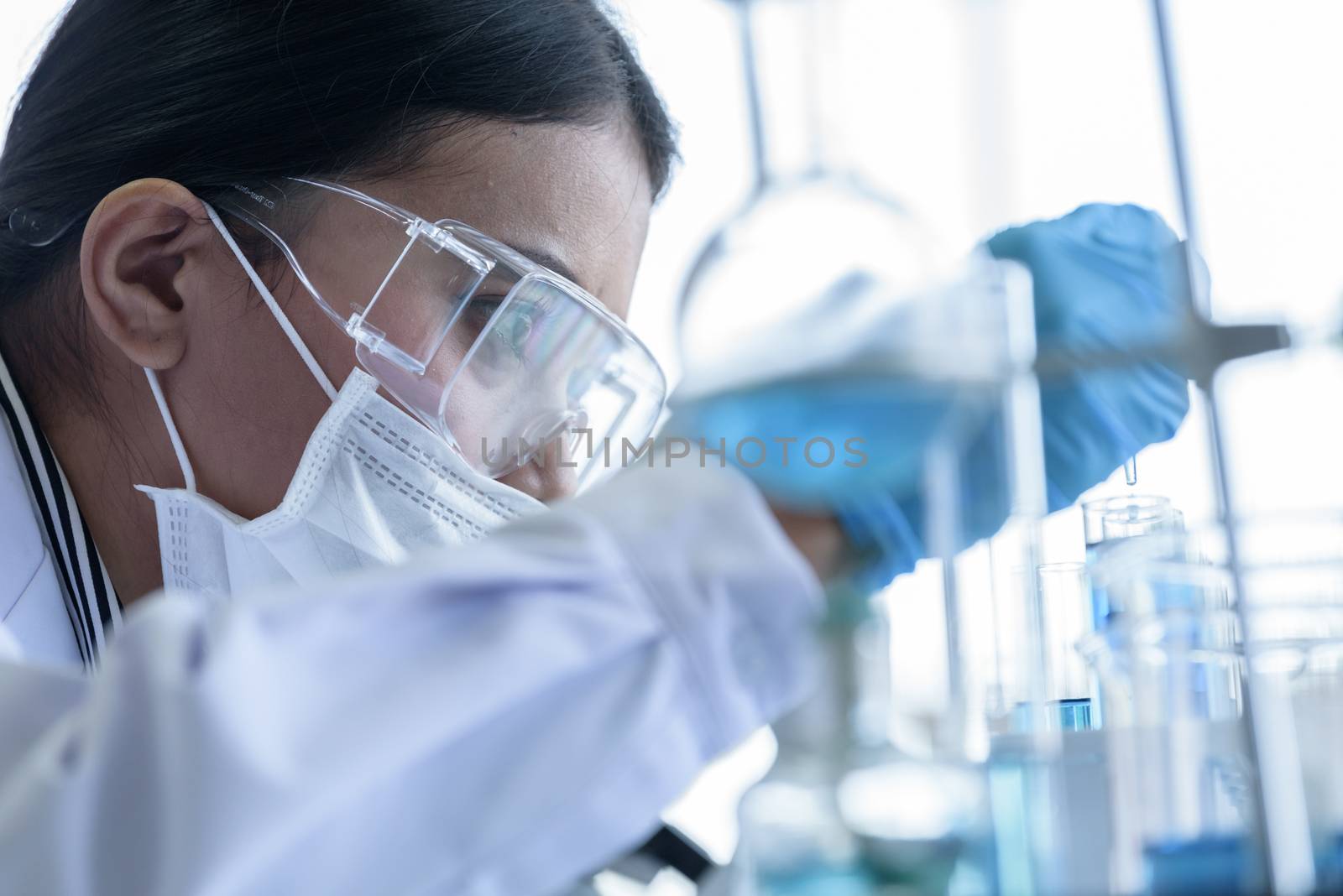 Asian young girl student scientist researching  and learning in a laboratory.