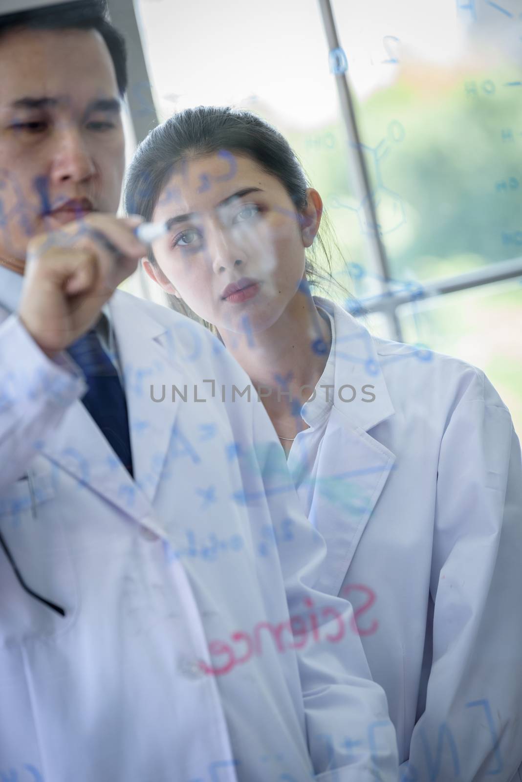 Asian scientist team has researching in laboratory.