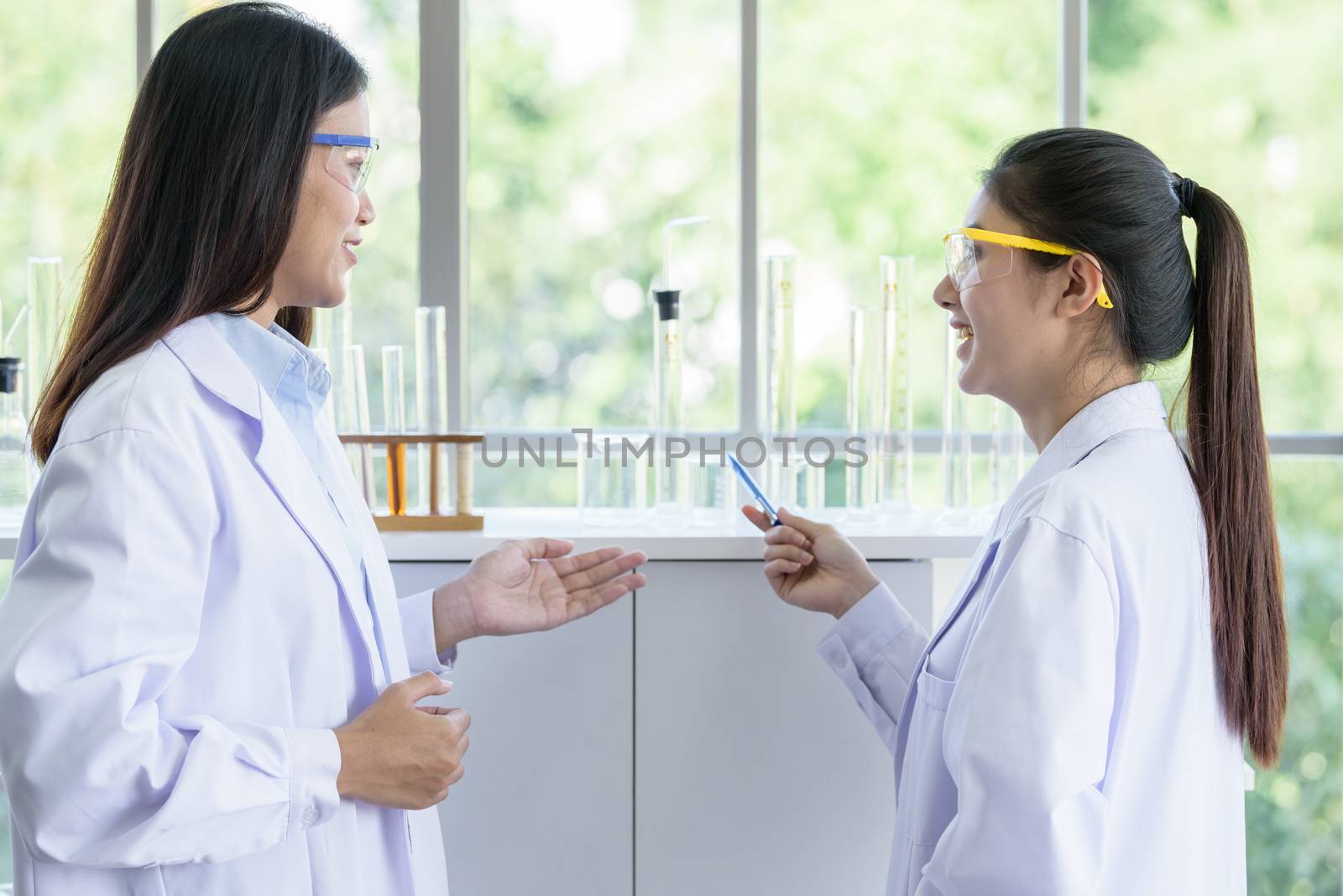 Asian young female working and research scientist together.