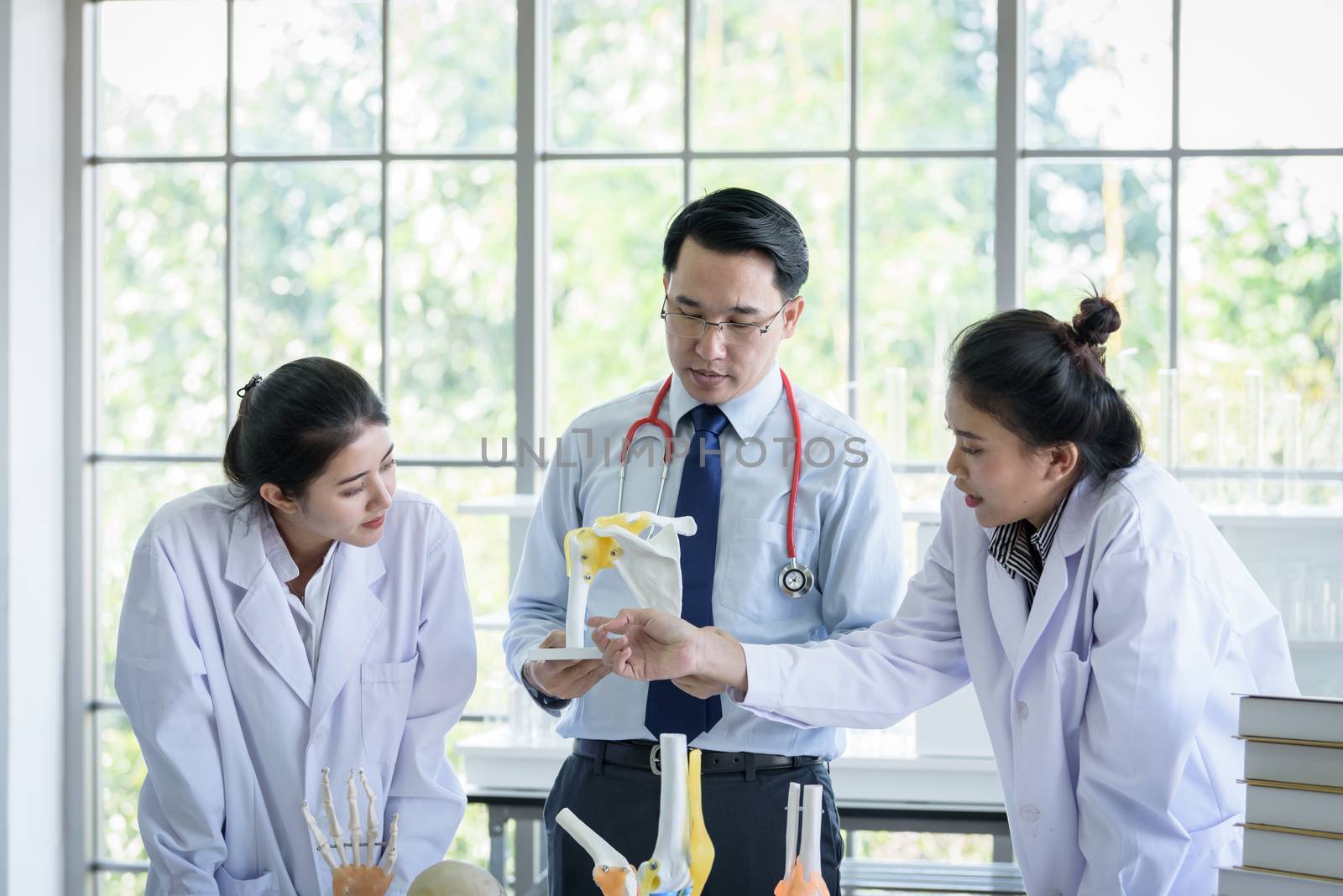 Asian teacher has teaching to student about science and anatomic by animagesdesign