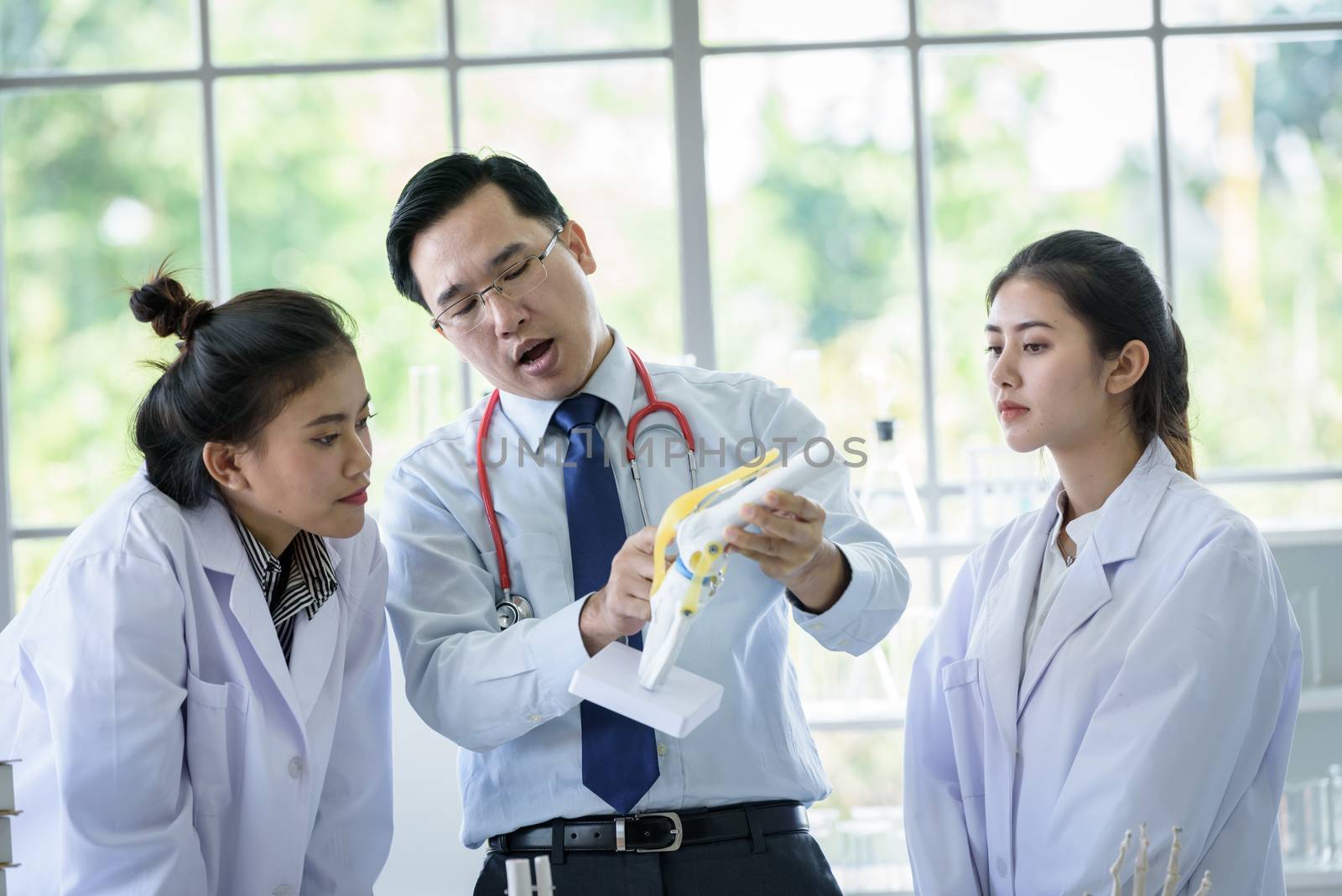 Asian teacher has teaching to student about science and anatomical in laboratory