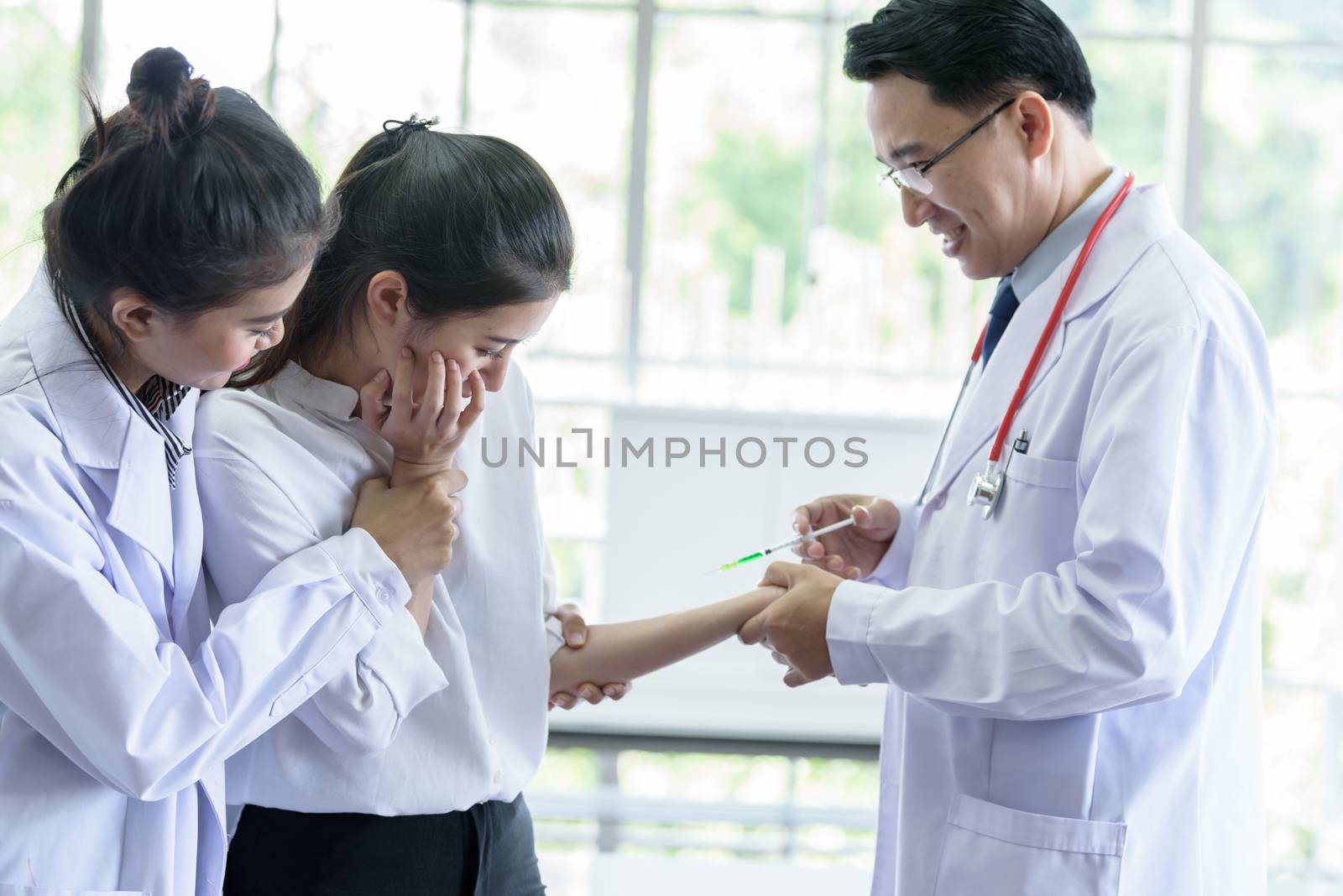 Patient has afraid and scary of syringe and needle. by animagesdesign