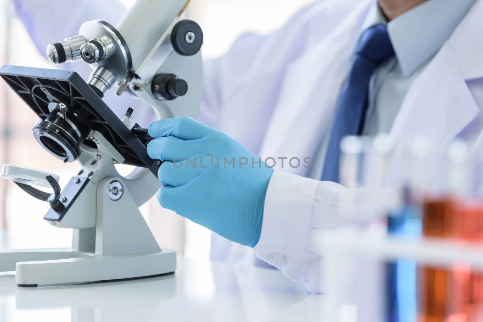 Asian man scientist researching  and learning in a laboratory.