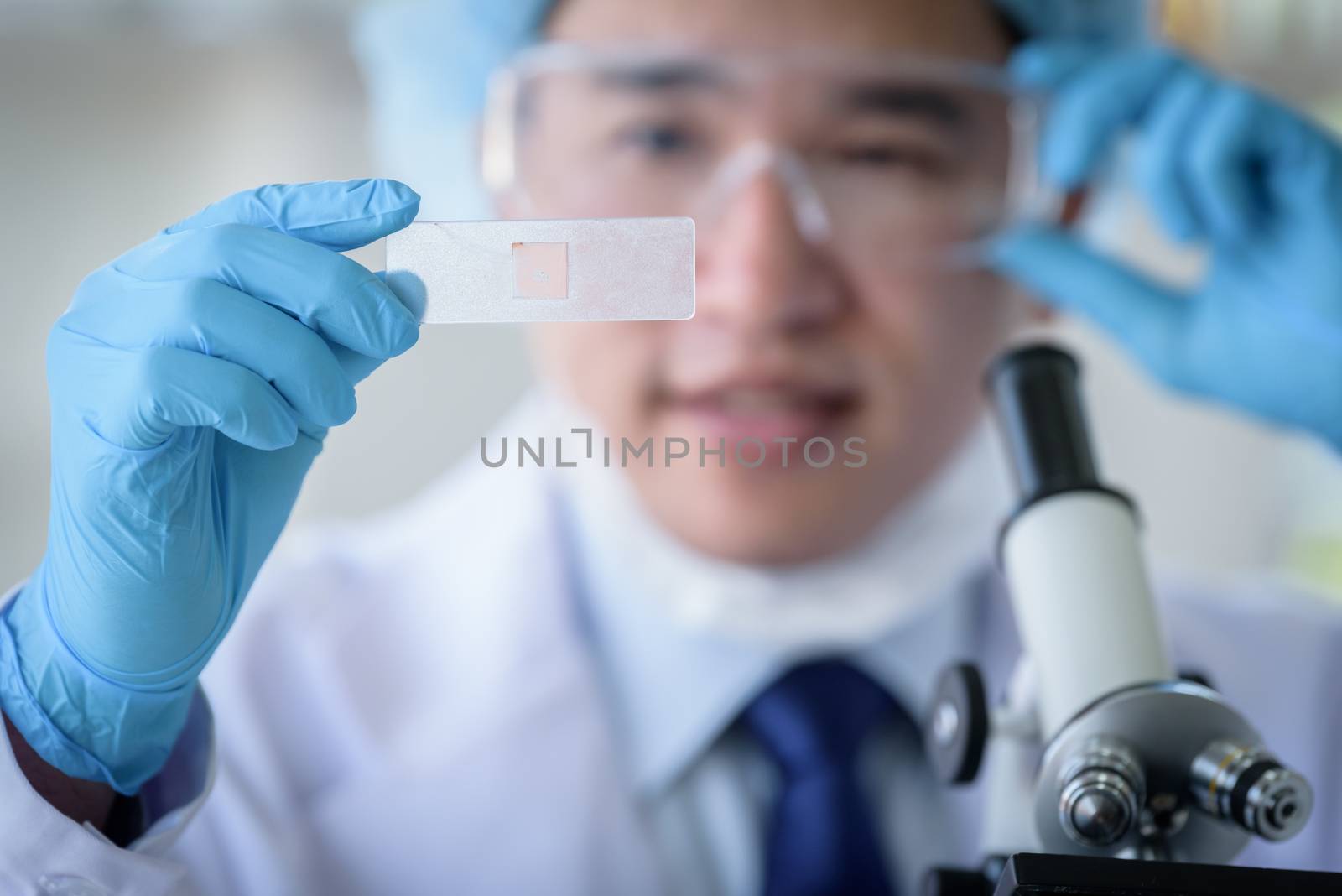 Asian man scientist researching  and learning in a laboratory.