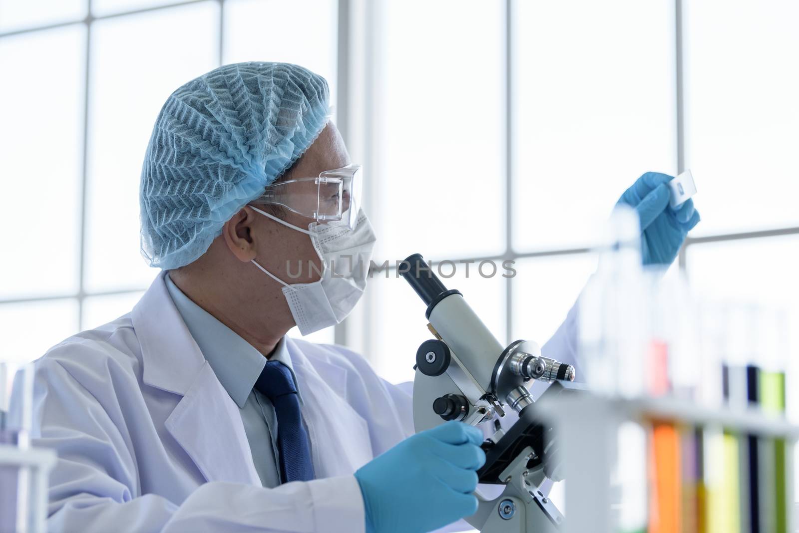 Asian man scientist researching  and learning in a laboratory.