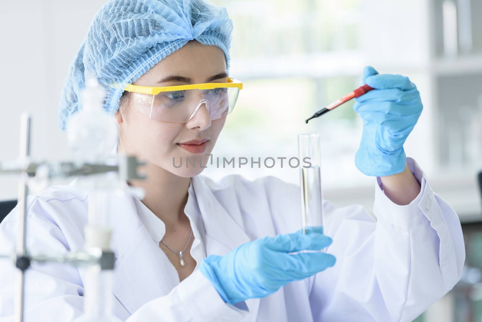 Asian young girl student scientist researching  and learning in a laboratory.