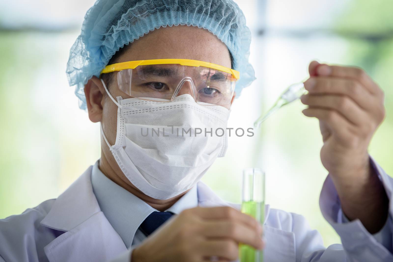 Asian senior scientist have teaching young student scientist in a laboratory.