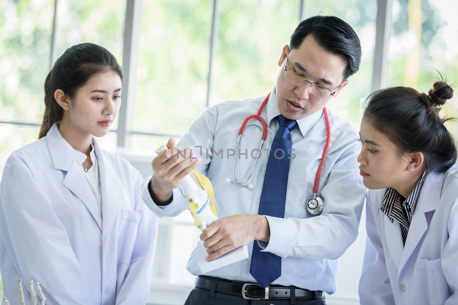 Asian teacher has teaching to student about science and anatomical in laboratory