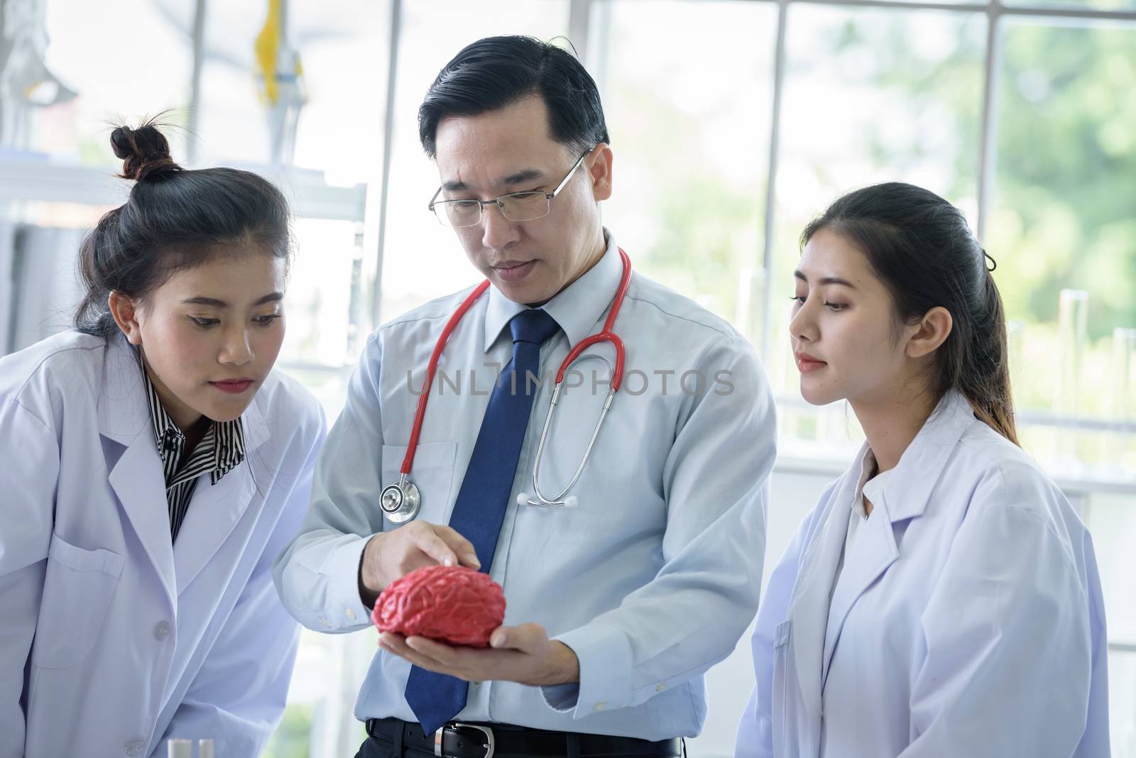 Asian teacher has teaching to student about science and anatomical in laboratory