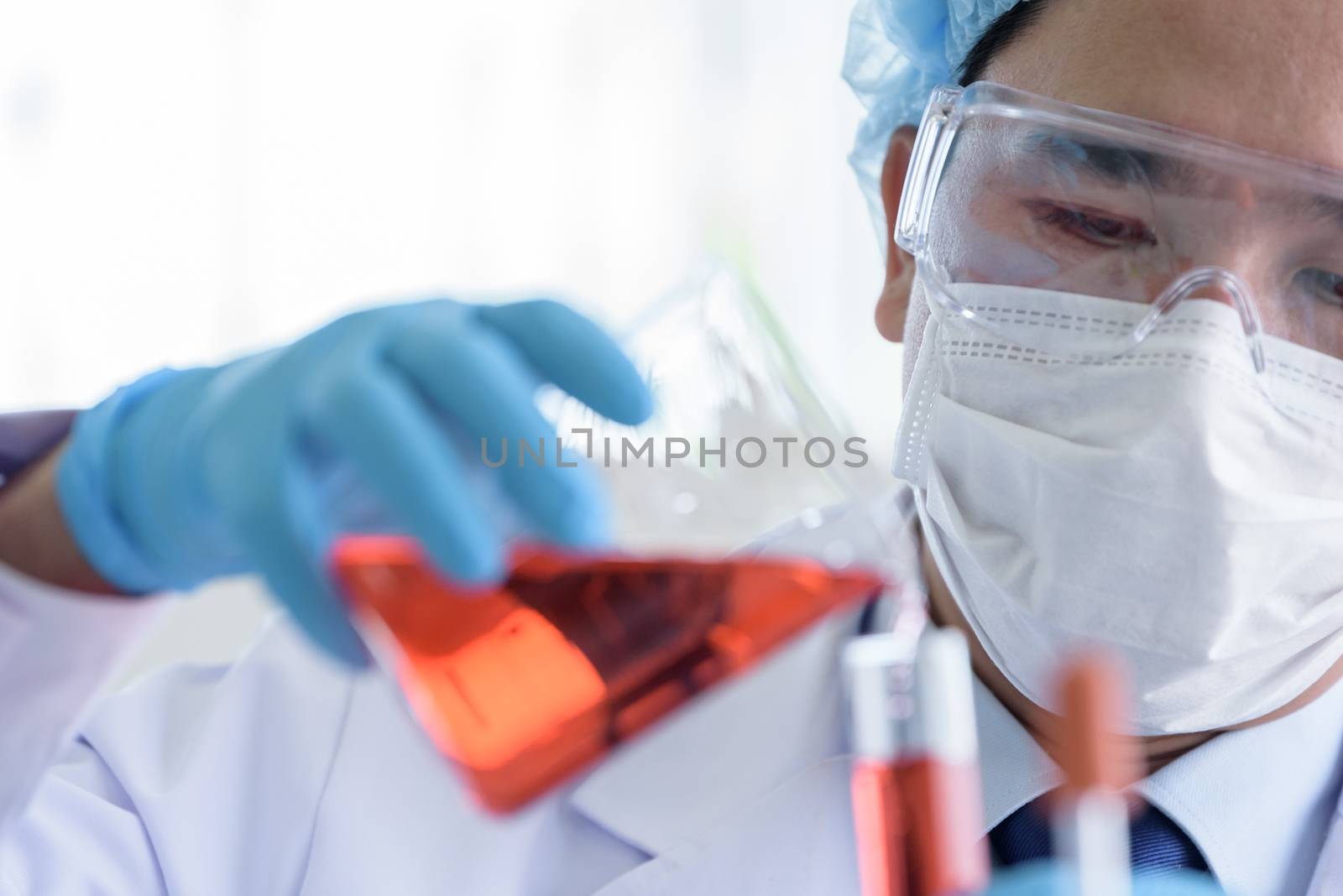 Asian man scientist researching  and learning in a laboratory. by animagesdesign