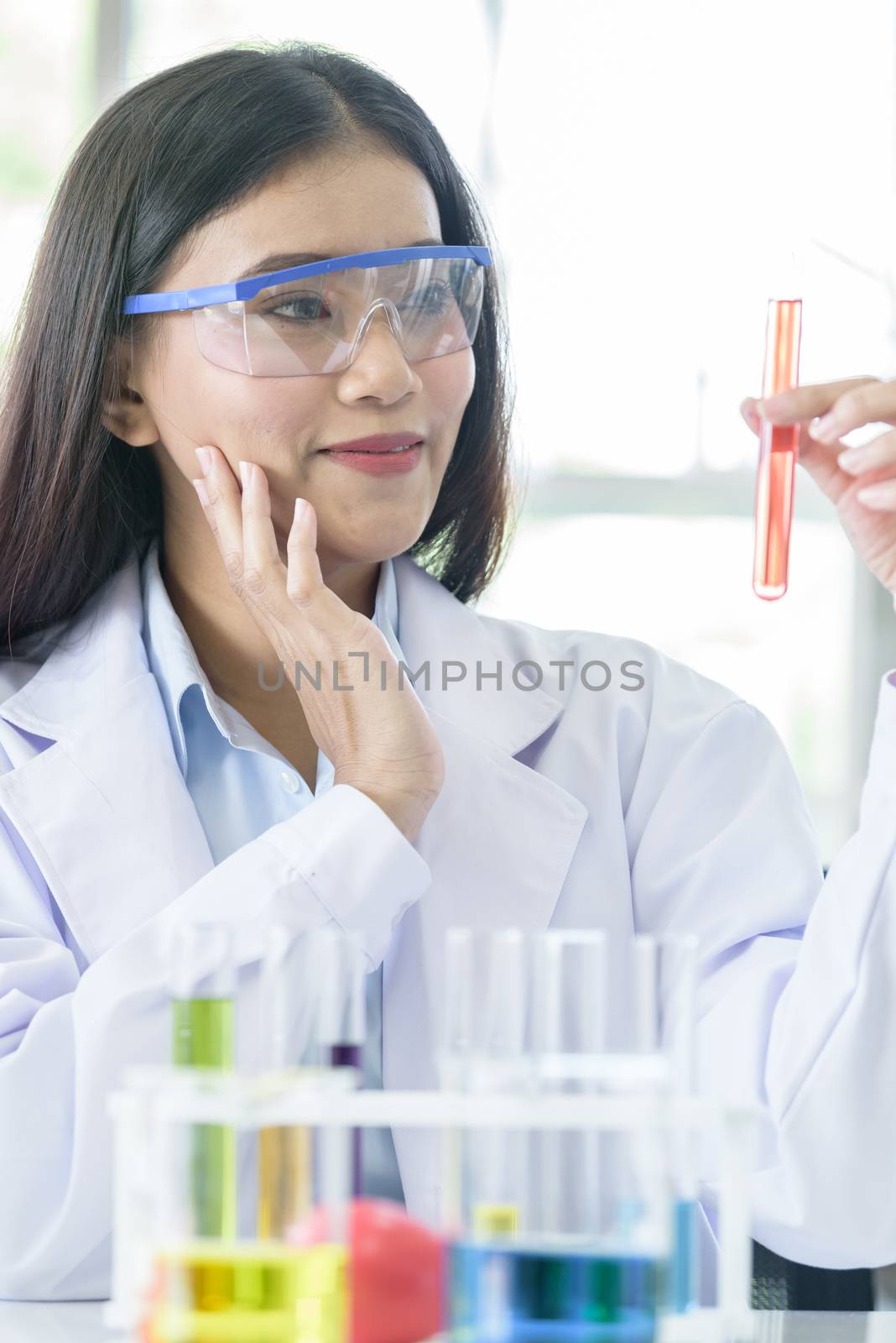 Asian young girl student scientist researching  and learning in a laboratory.