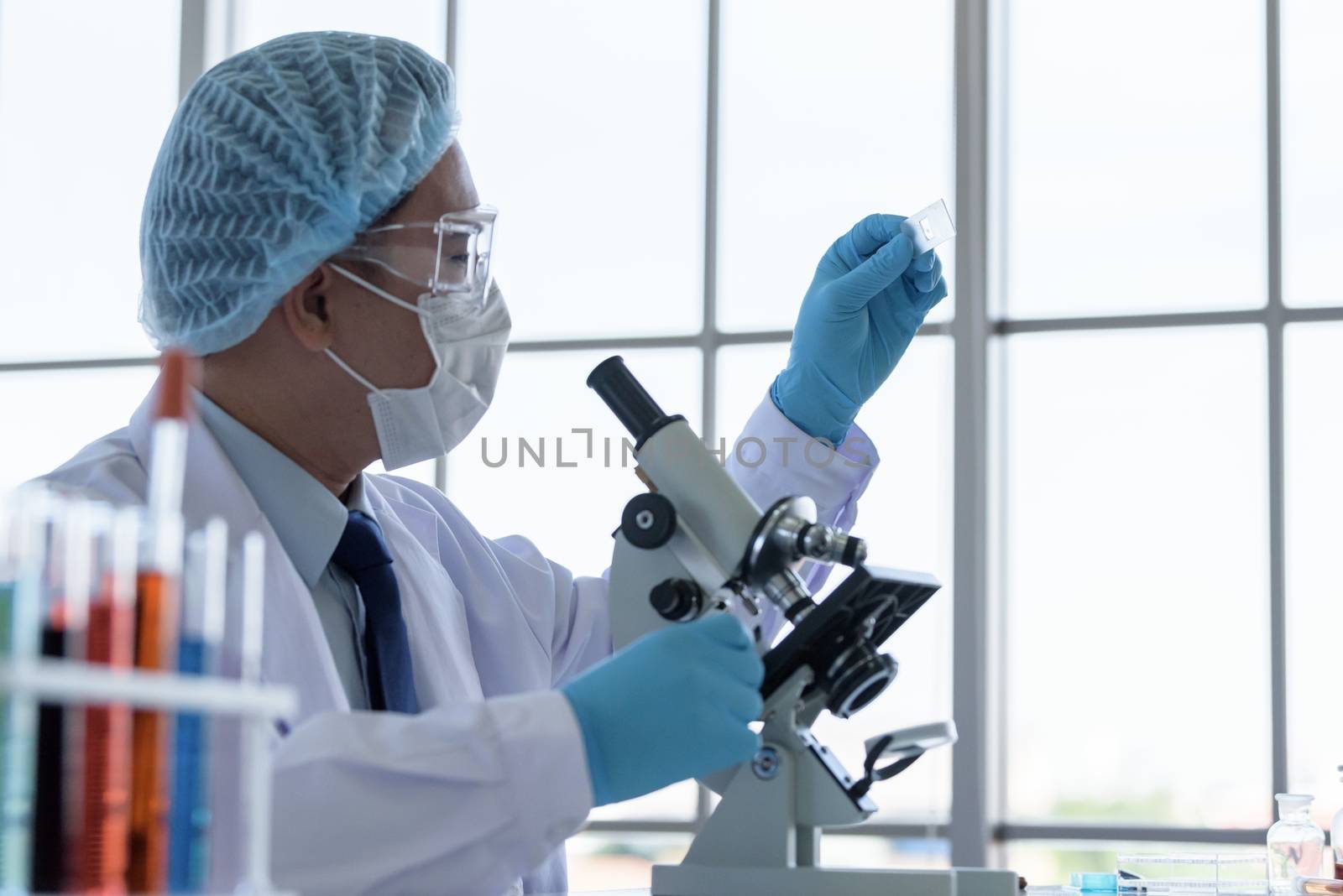 Asian man scientist researching  and learning in a laboratory.