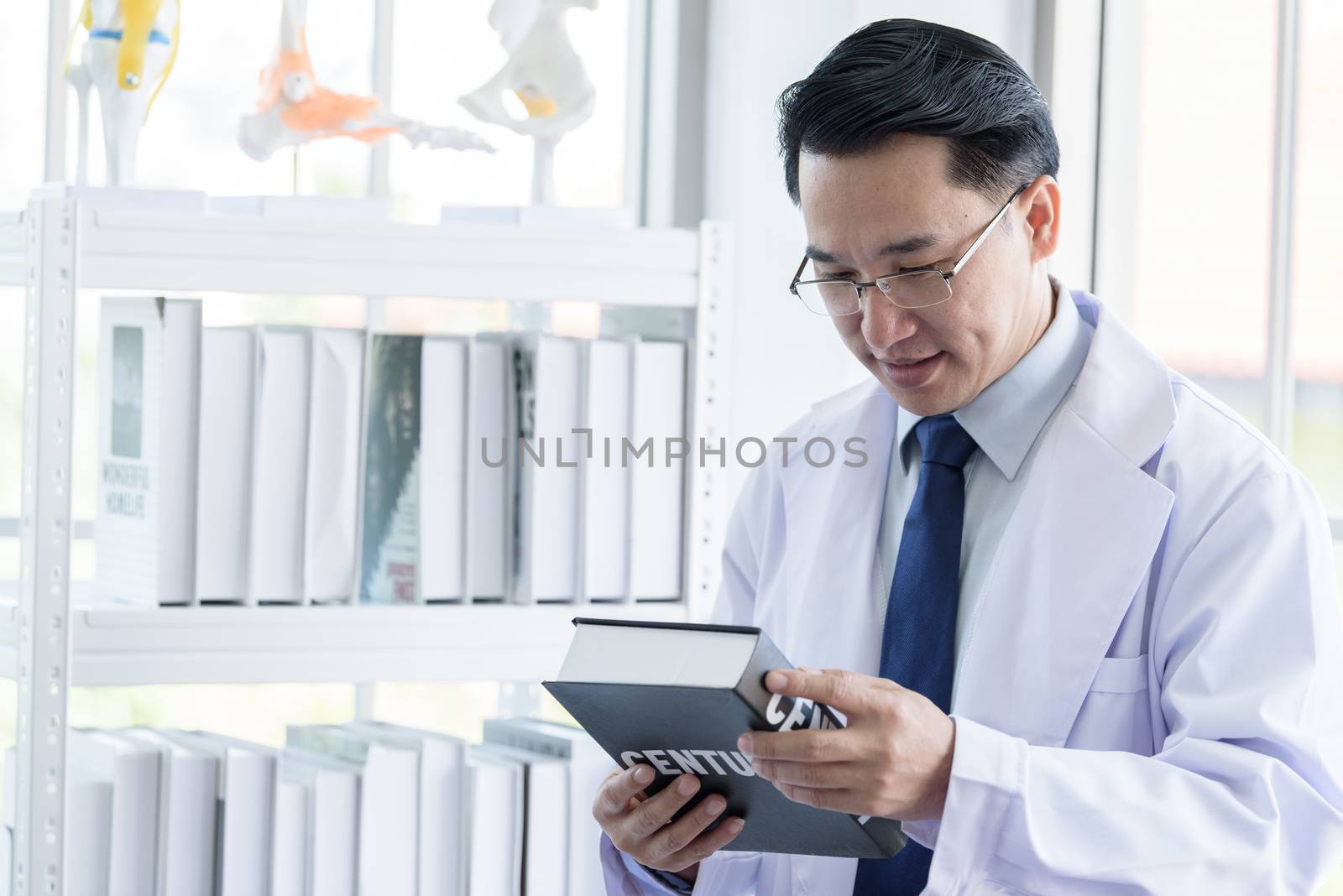 Asian senior scientist researching and learning in a laboratory. by animagesdesign