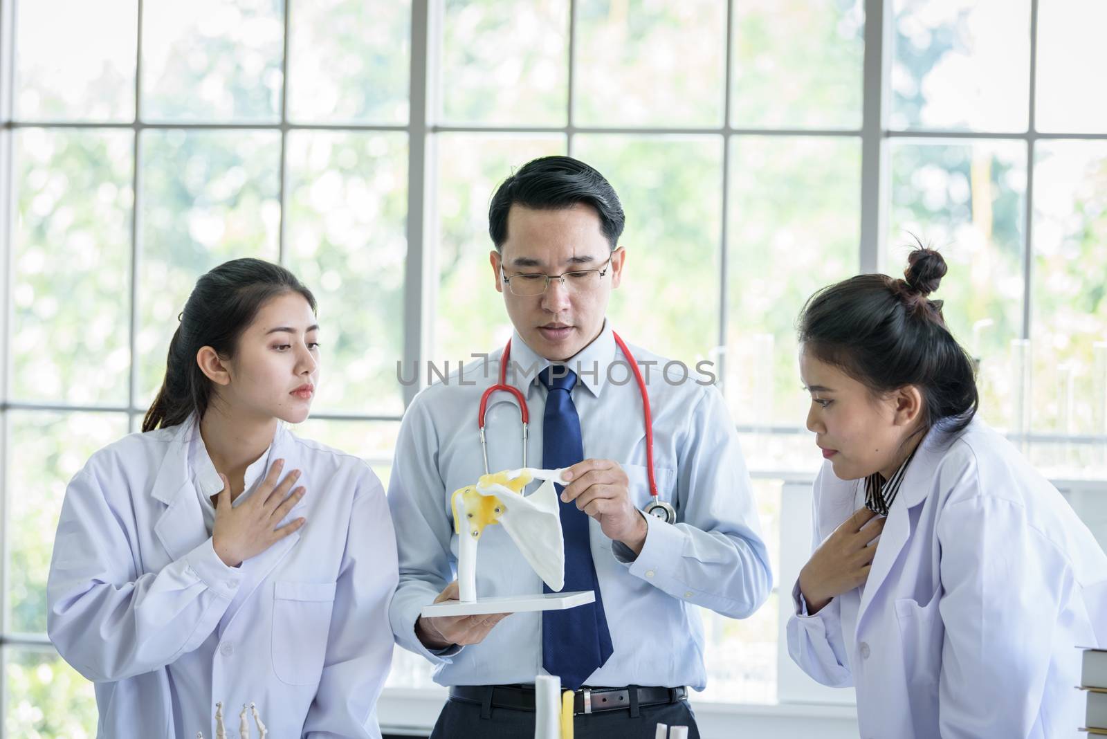 Asian teacher has teaching to student about science and anatomical in laboratory