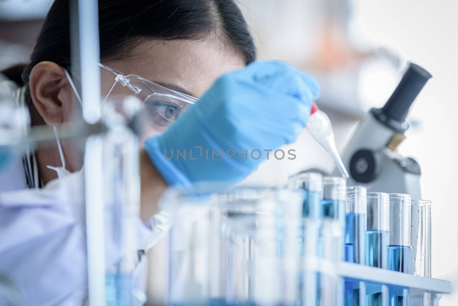 Asian young girl student scientist researching  and learning in a laboratory.