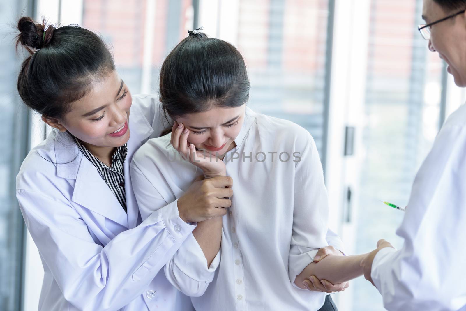 Patient has afraid and scary of syringe and needle. by animagesdesign