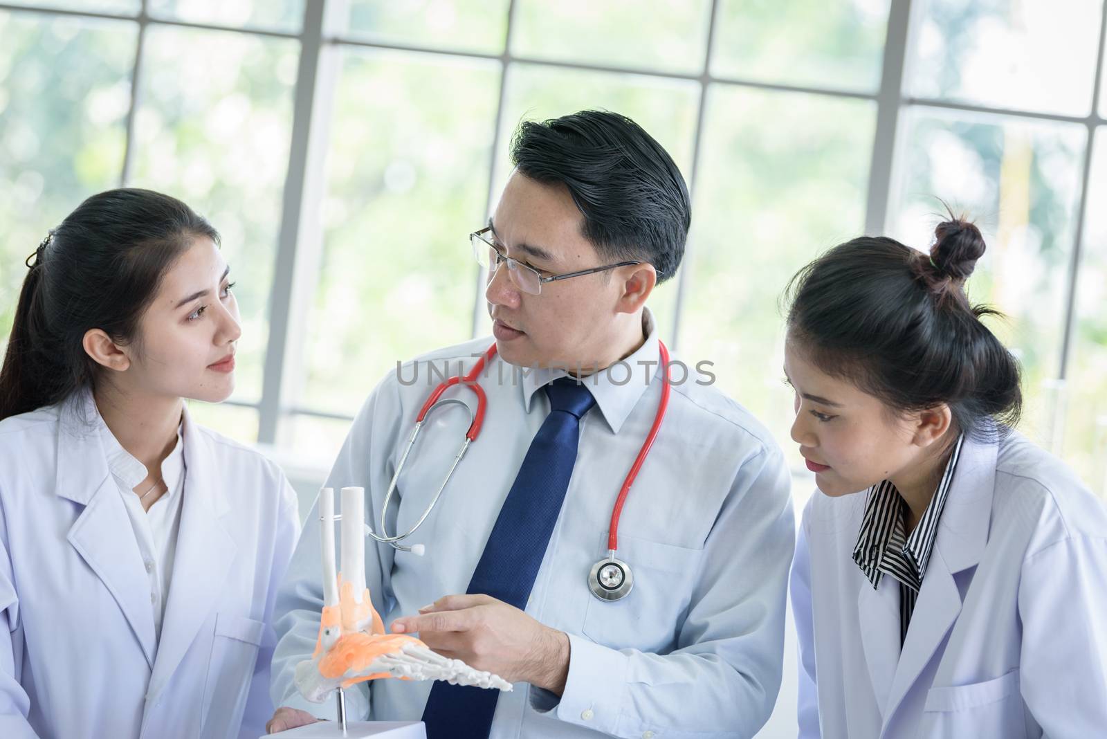 Asian teacher has teaching to student about science and anatomical in laboratory