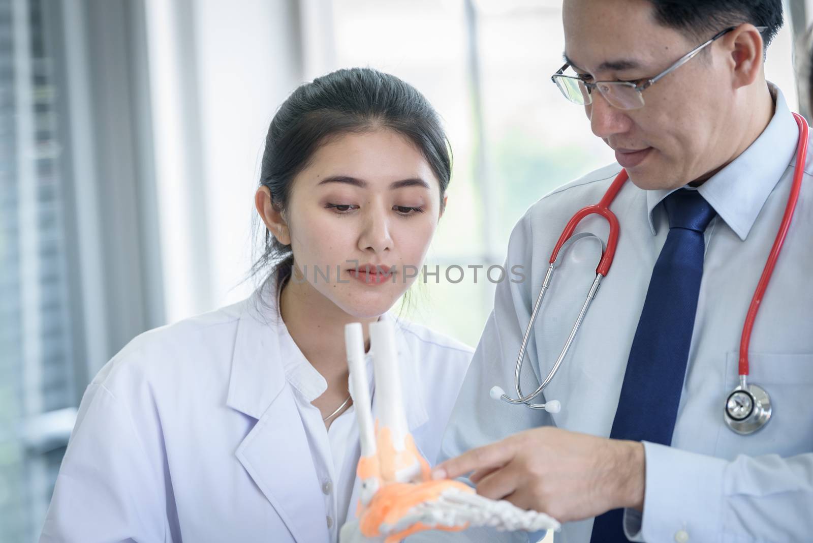 Asian teacher has teaching to student about science and anatomical in laboratory