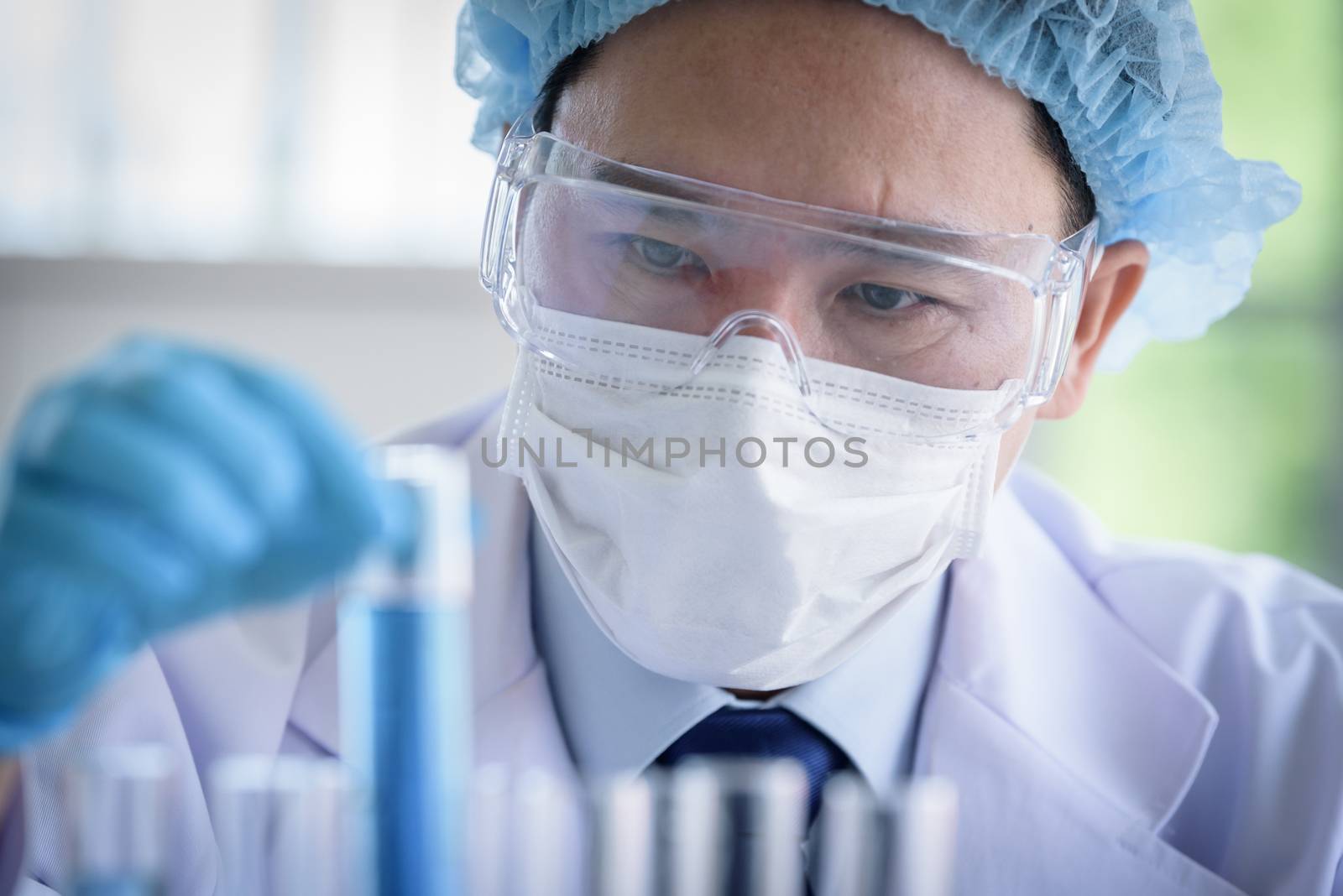 Asian man scientist researching  and learning in a laboratory.