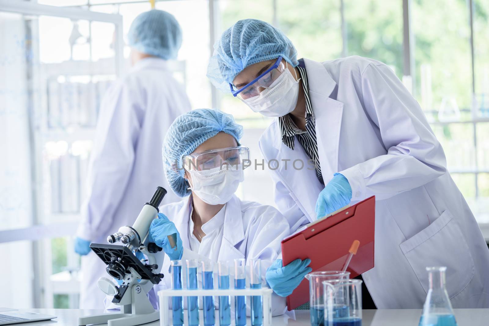 Asian scientist team has researching in laboratory.