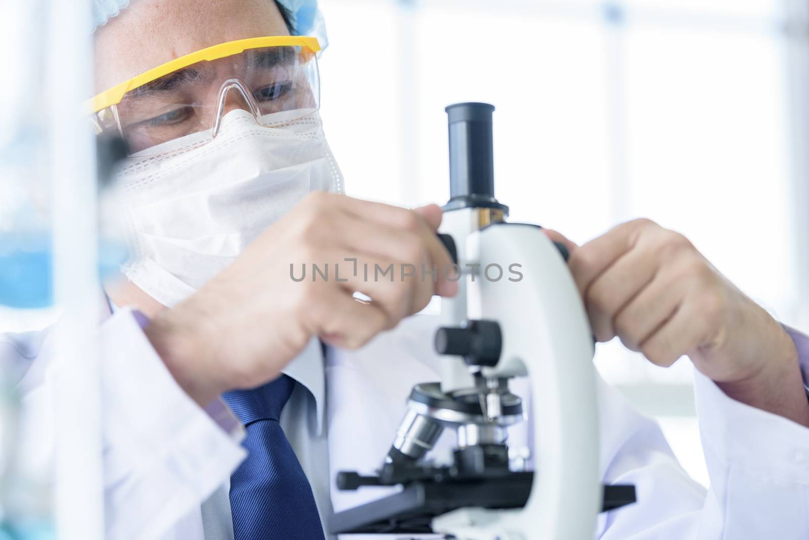 Asian young man student scientist researching  and learning in a laboratory.