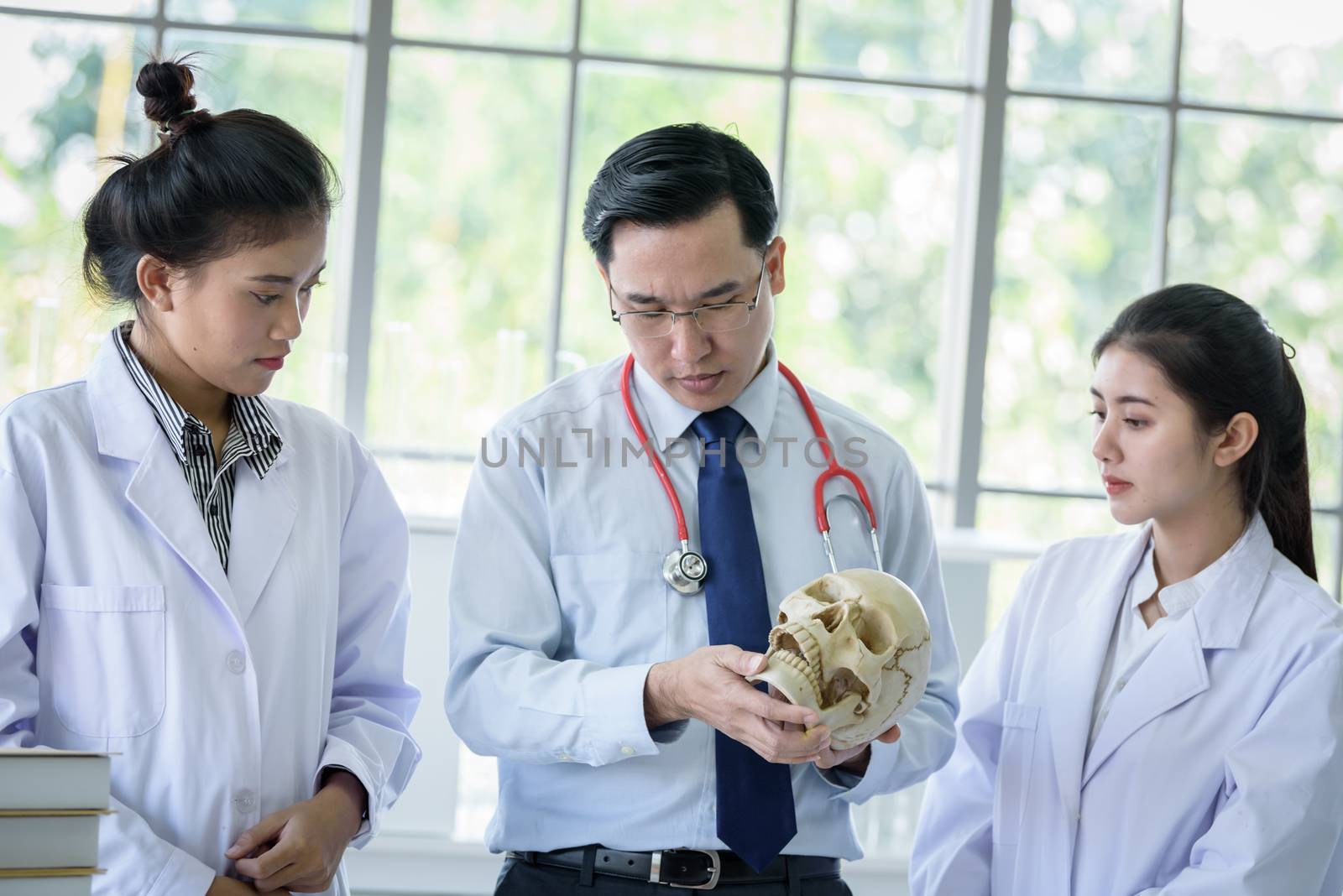 Asian teacher has teaching to student about science and anatomical in laboratory