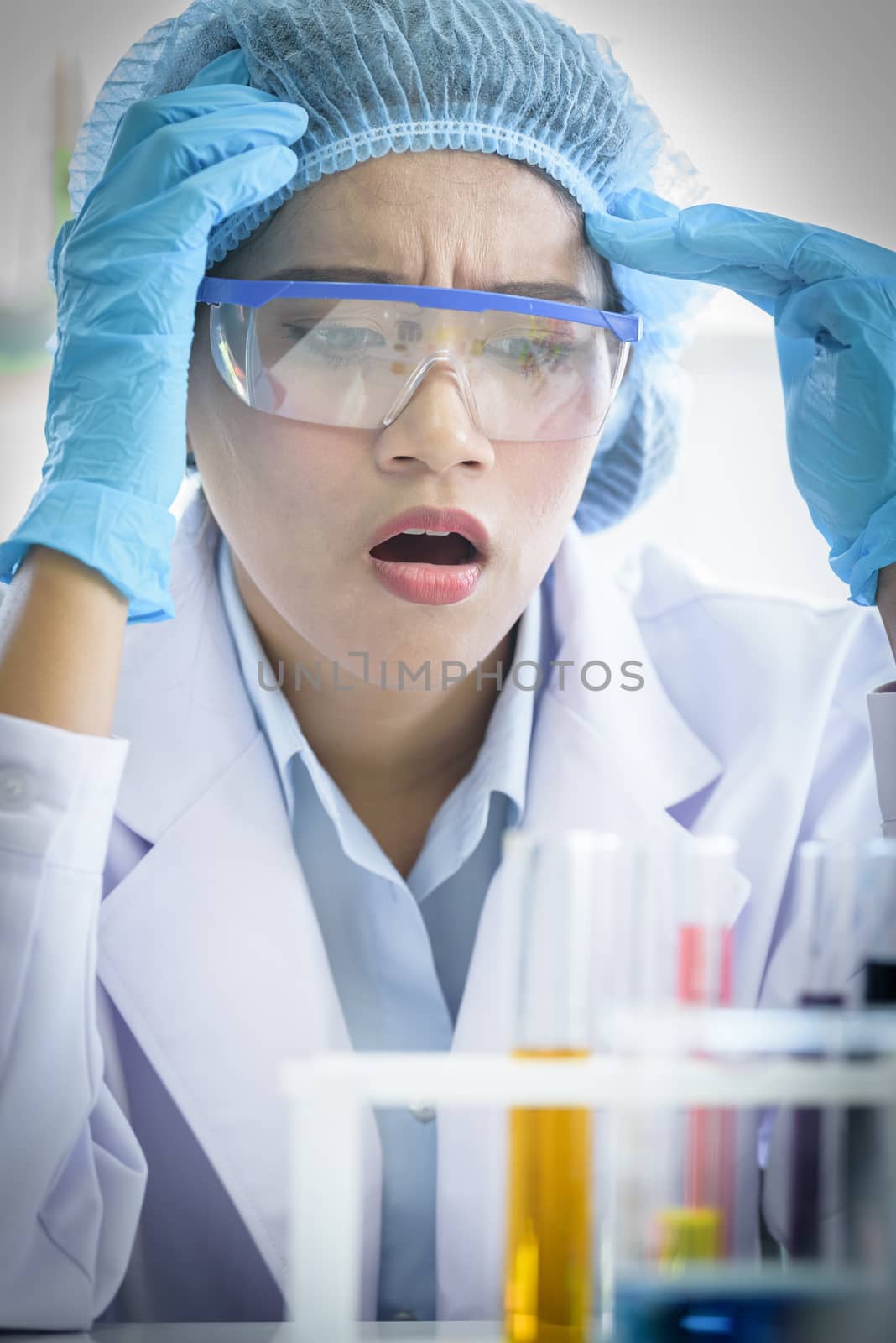 Asian young girl student scientist feeling sad researching  and learning in a laboratory.