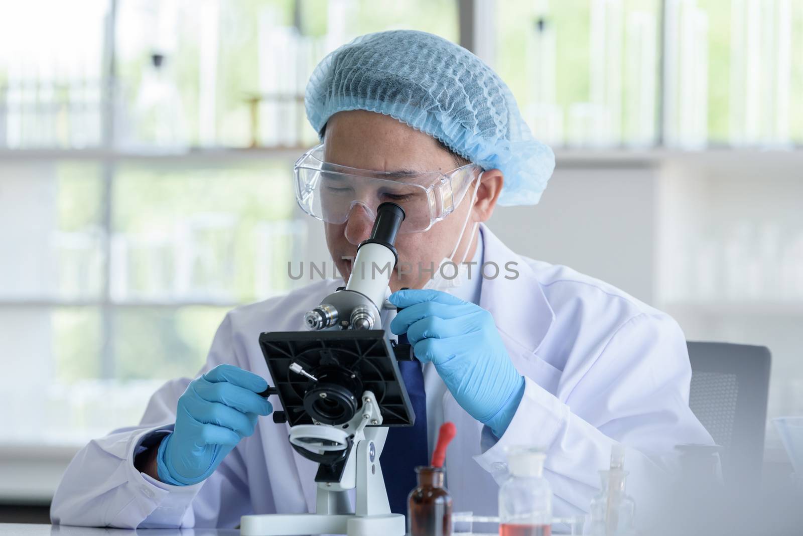 Asian man scientist researching  and learning in a laboratory.