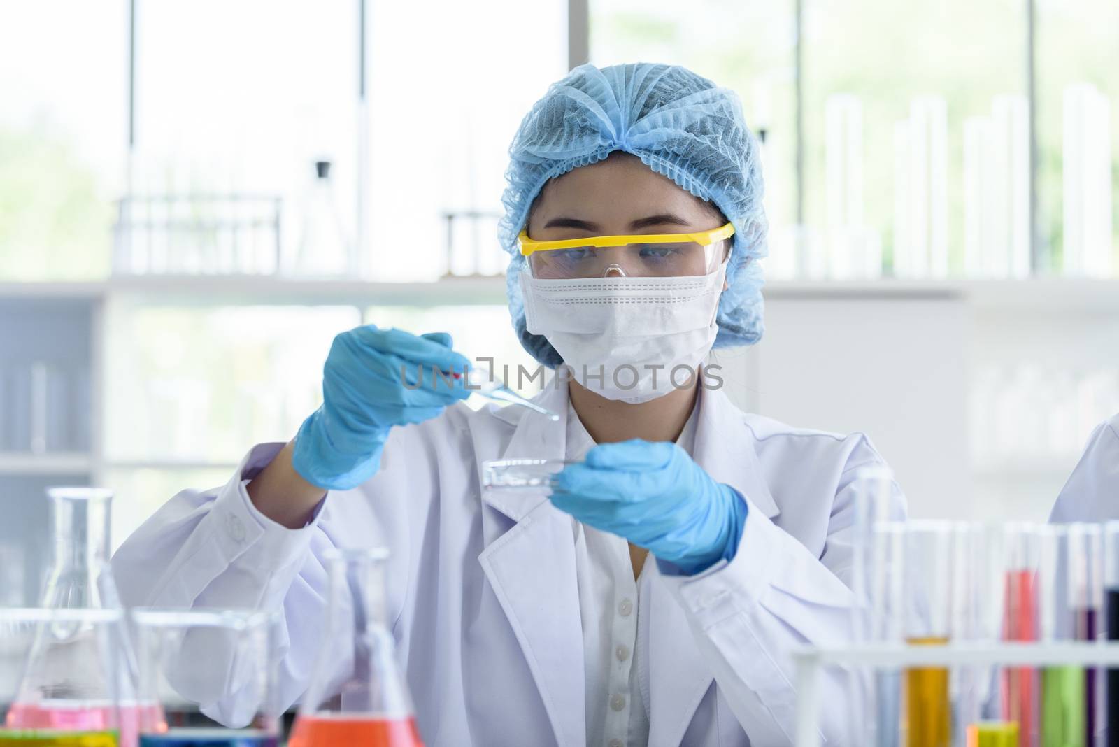 Asian young girl student scientist researching  and learning in a laboratory.