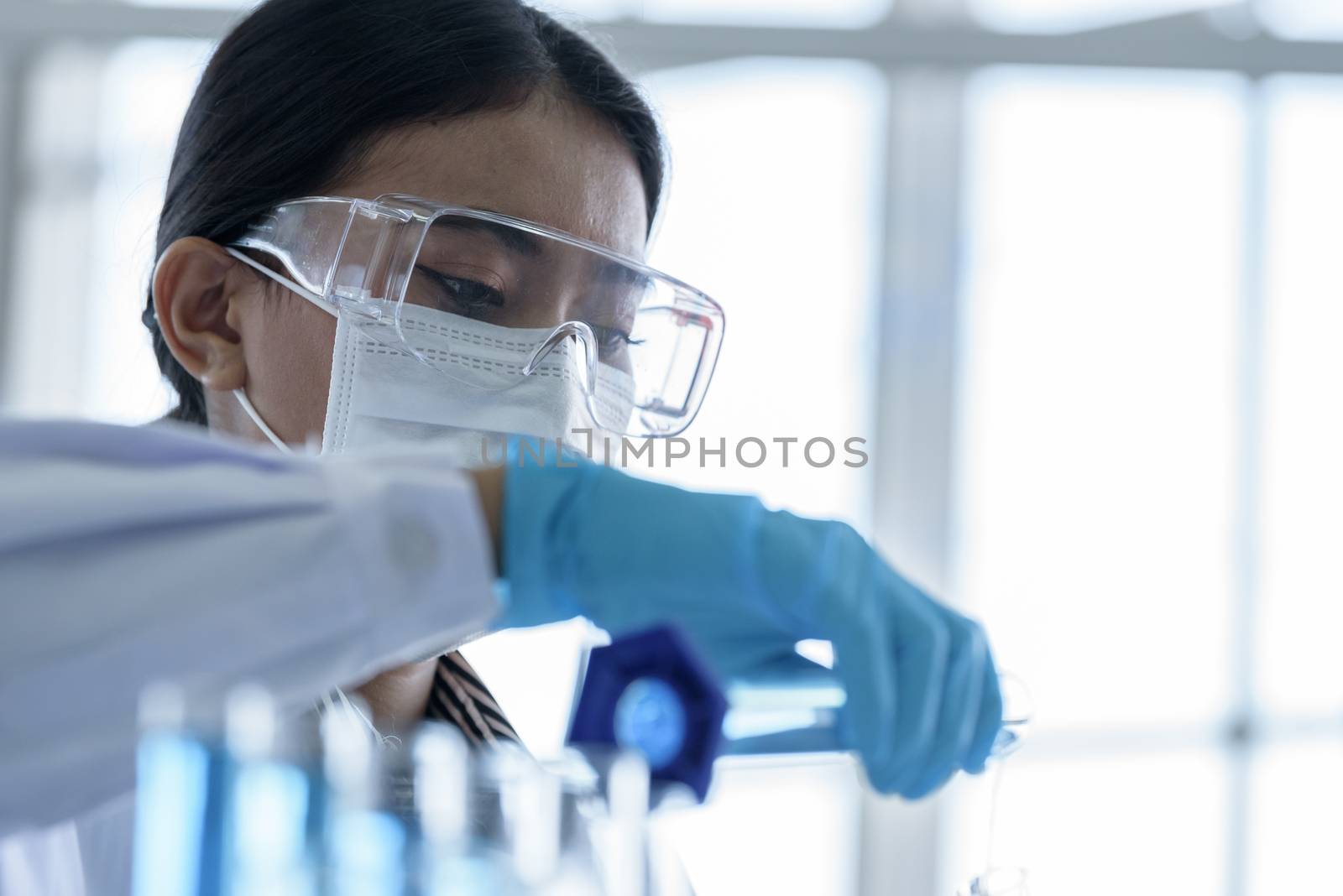 Asian young girl student scientist researching  and learning in a laboratory.