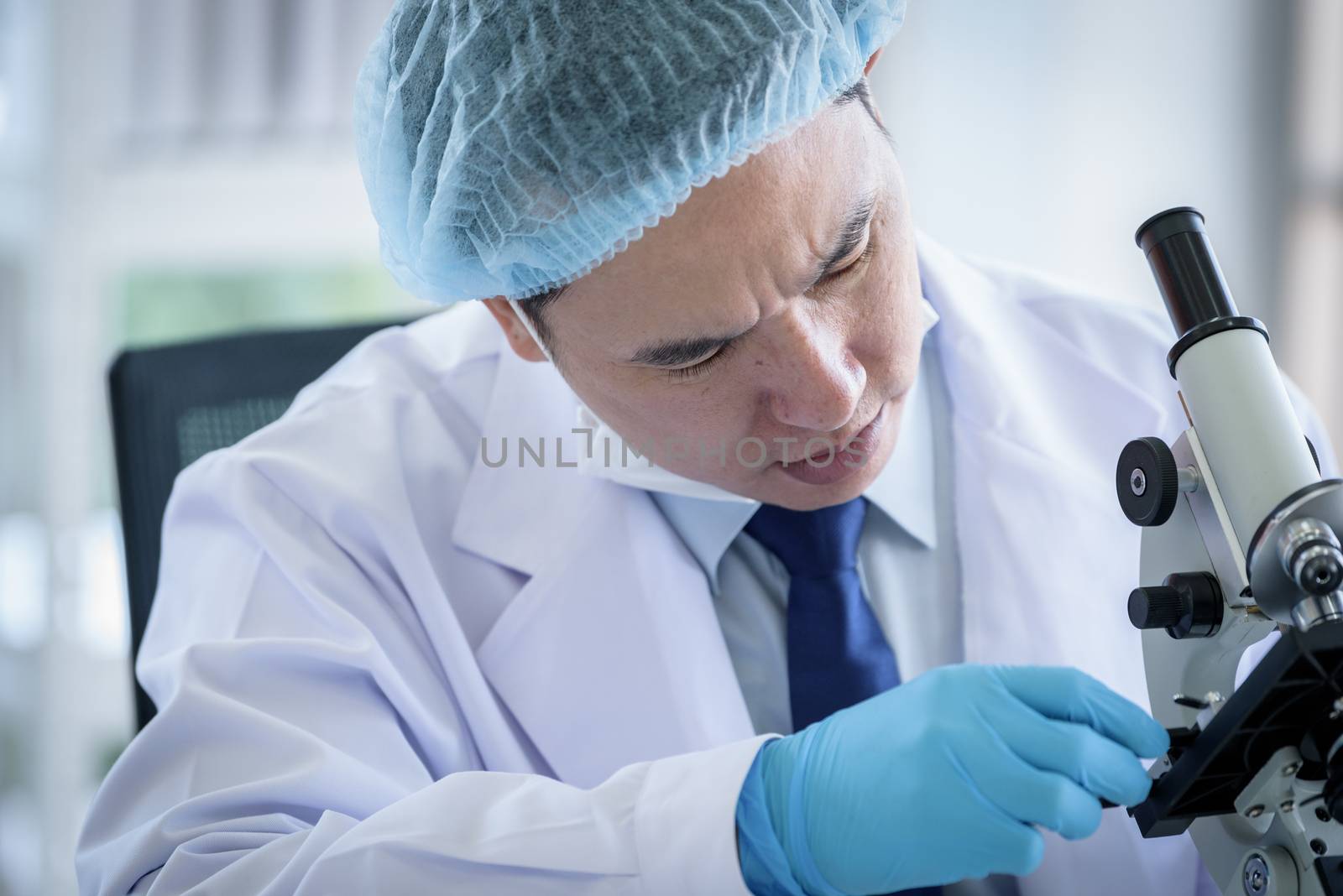 Asian man scientist researching  and learning in a laboratory. by animagesdesign