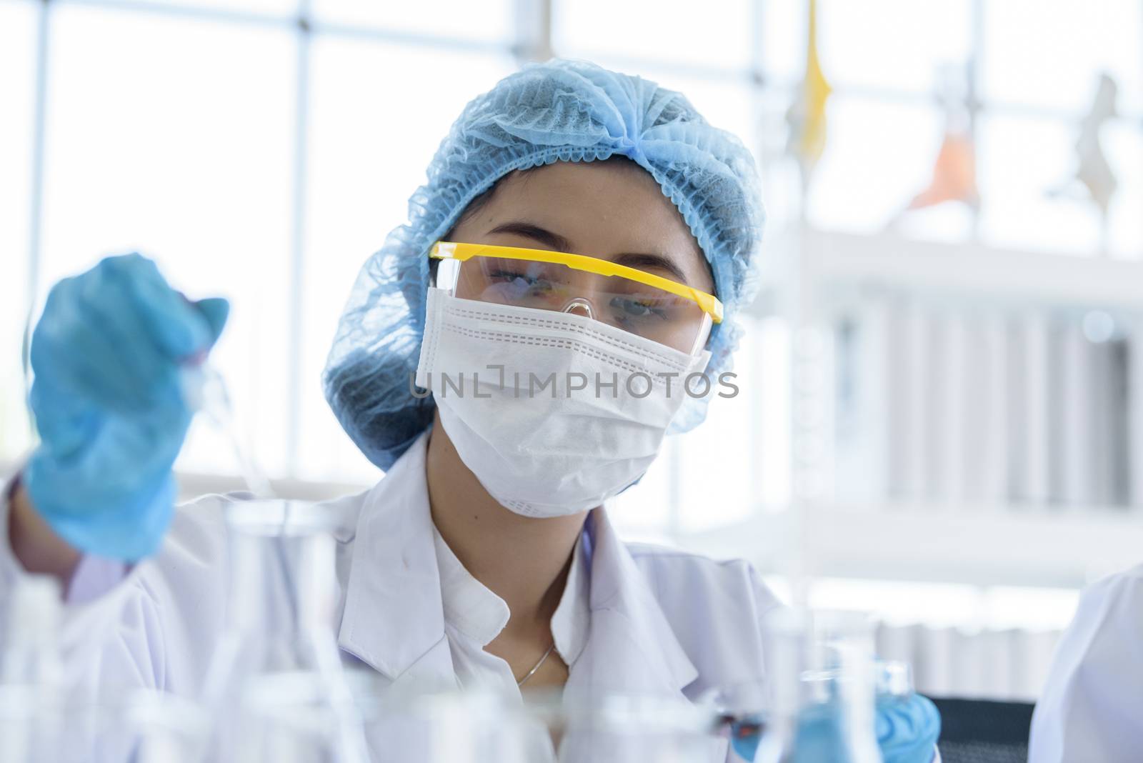 Asian young girl student scientist researching  and learning in  by animagesdesign