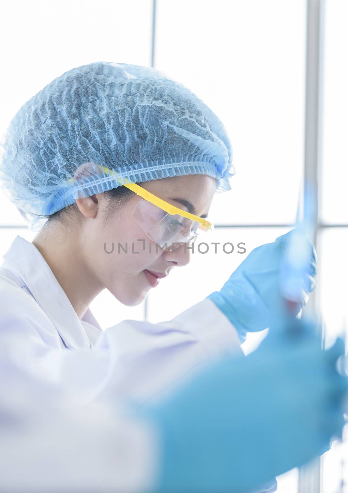 Asian young girl student scientist researching  and learning in a laboratory.