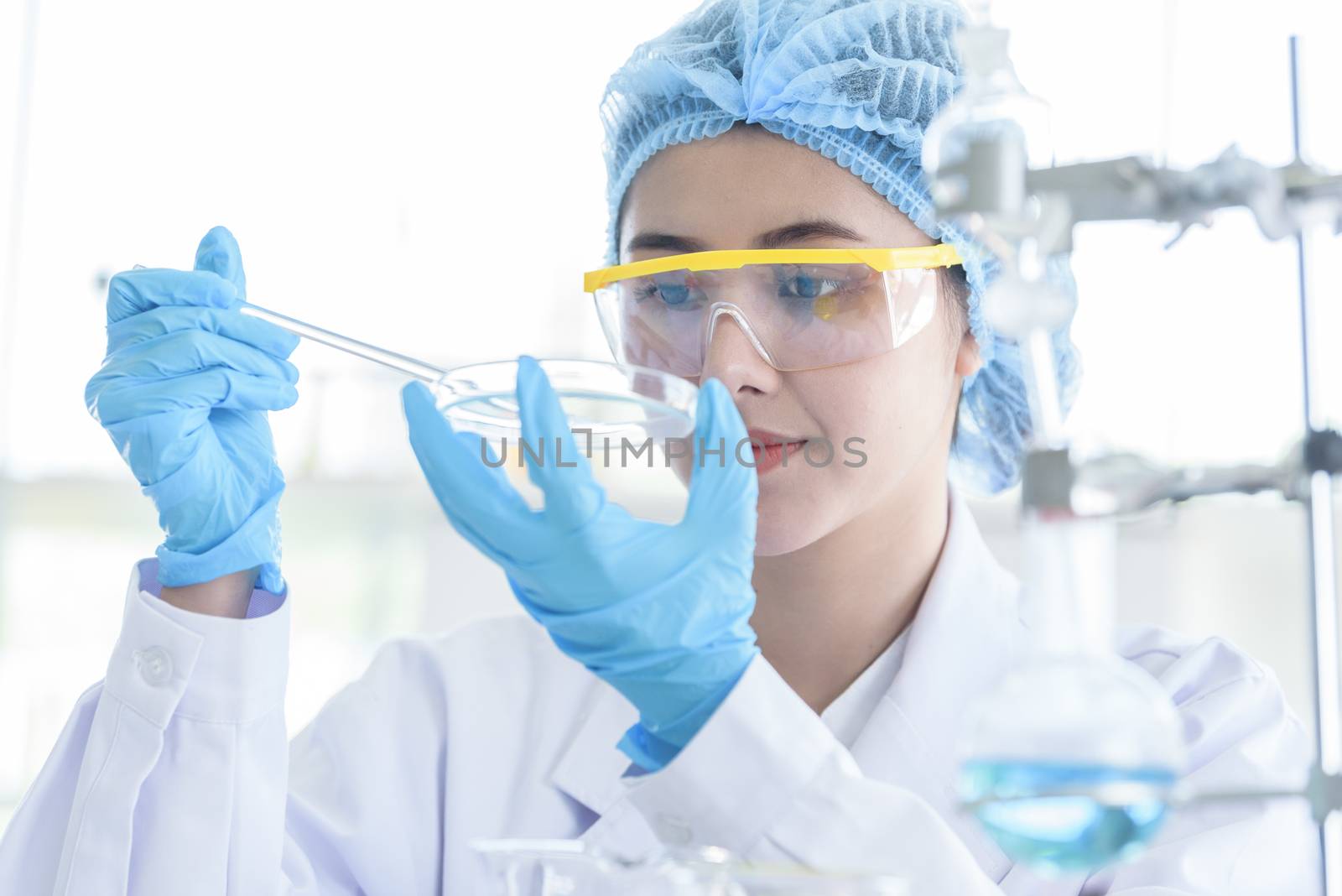 Asian young girl student scientist researching  and learning in a laboratory.