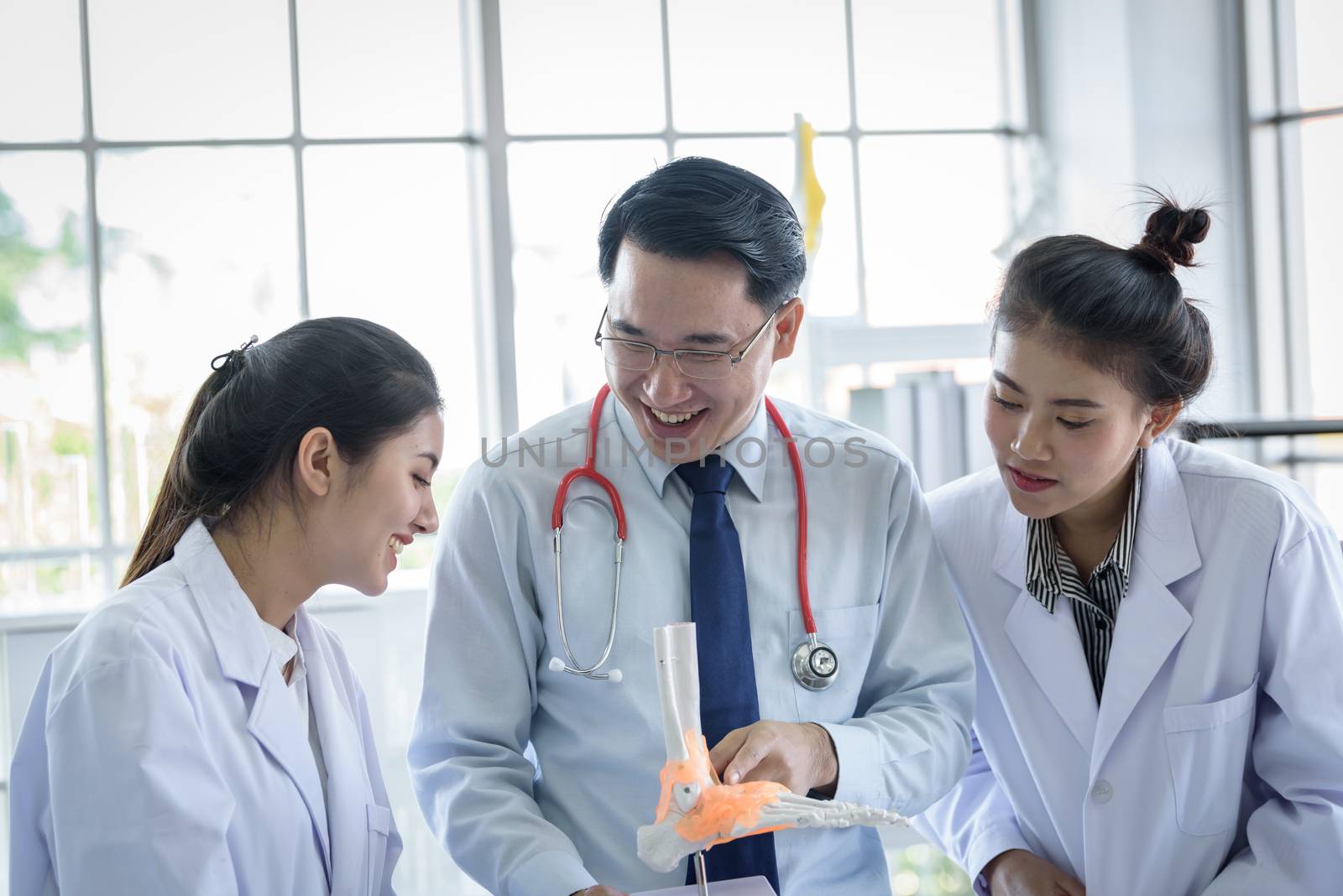 Asian teacher has teaching to student about science and anatomical in laboratory